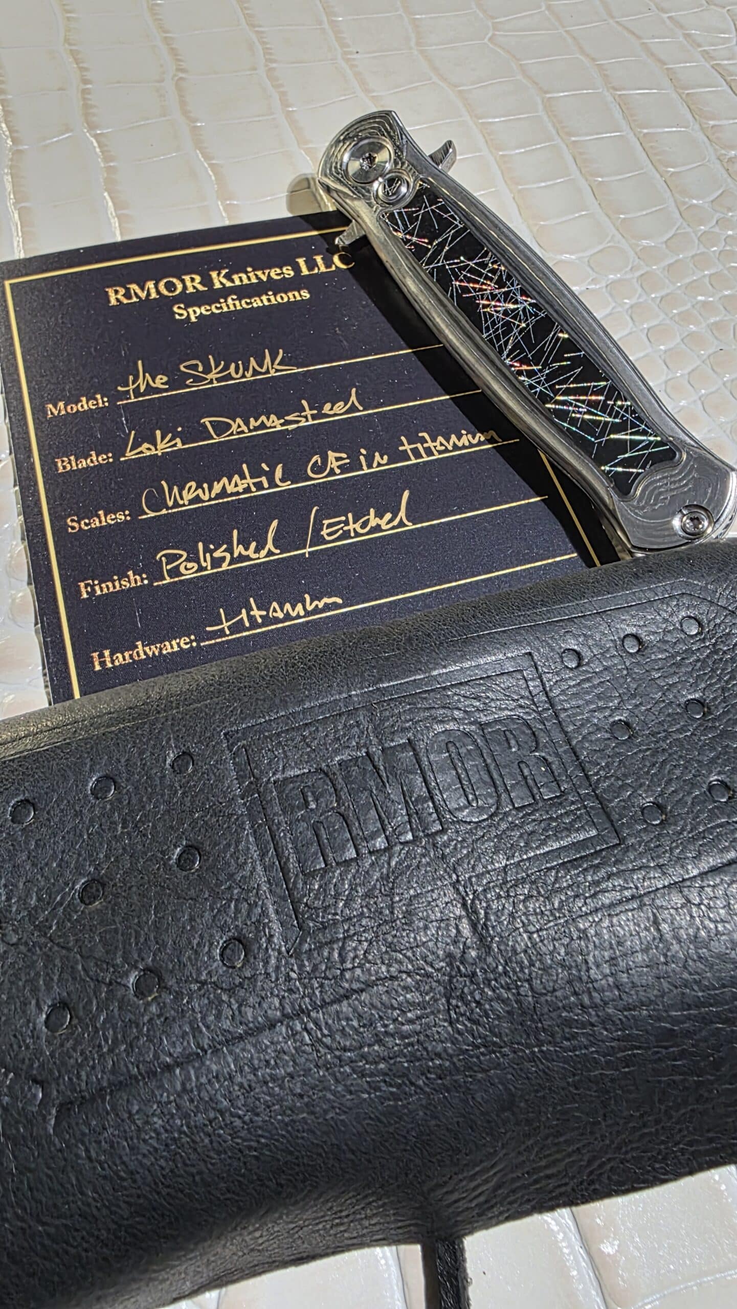 RMOR Knives Skunk custom folding knife with Loki Damascus blade and chaotic carbon fiber inlaid titanium handle
