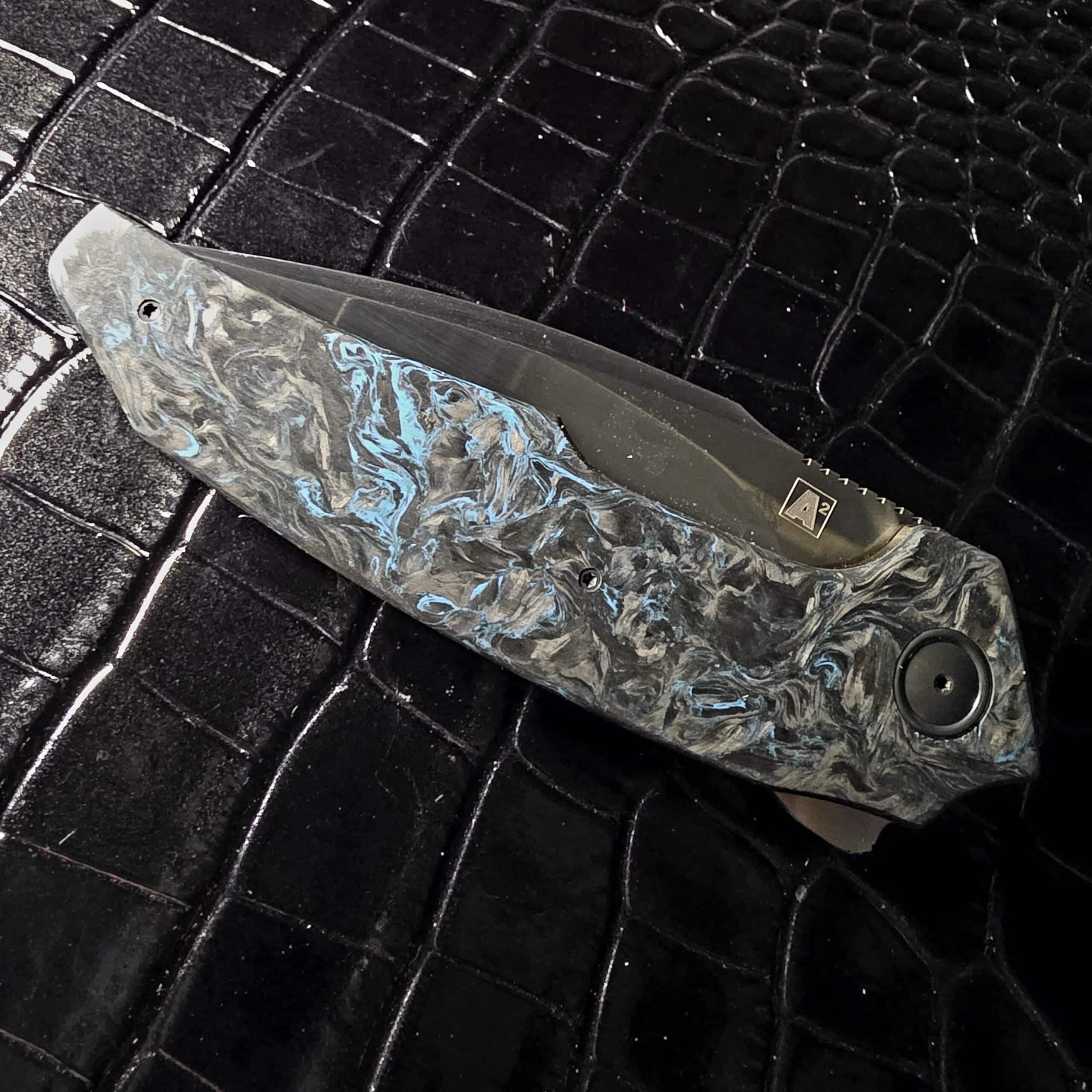 A2 Knives A6R Flipper FatCarbon scales under light showing blue depth and pattern shift