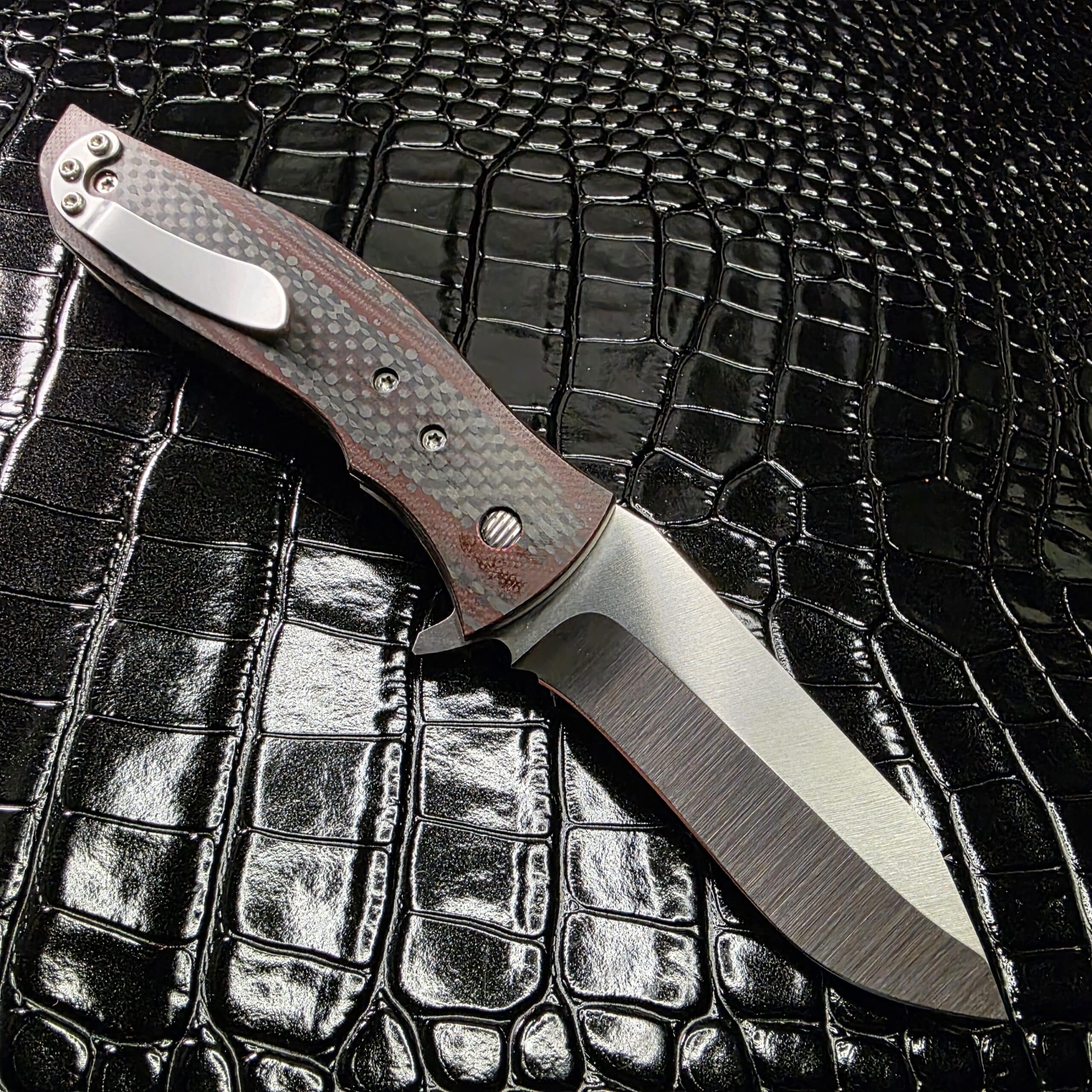Clip side of Greg Lightfoot Bullwhip showing pocket clip and lock mechanism.