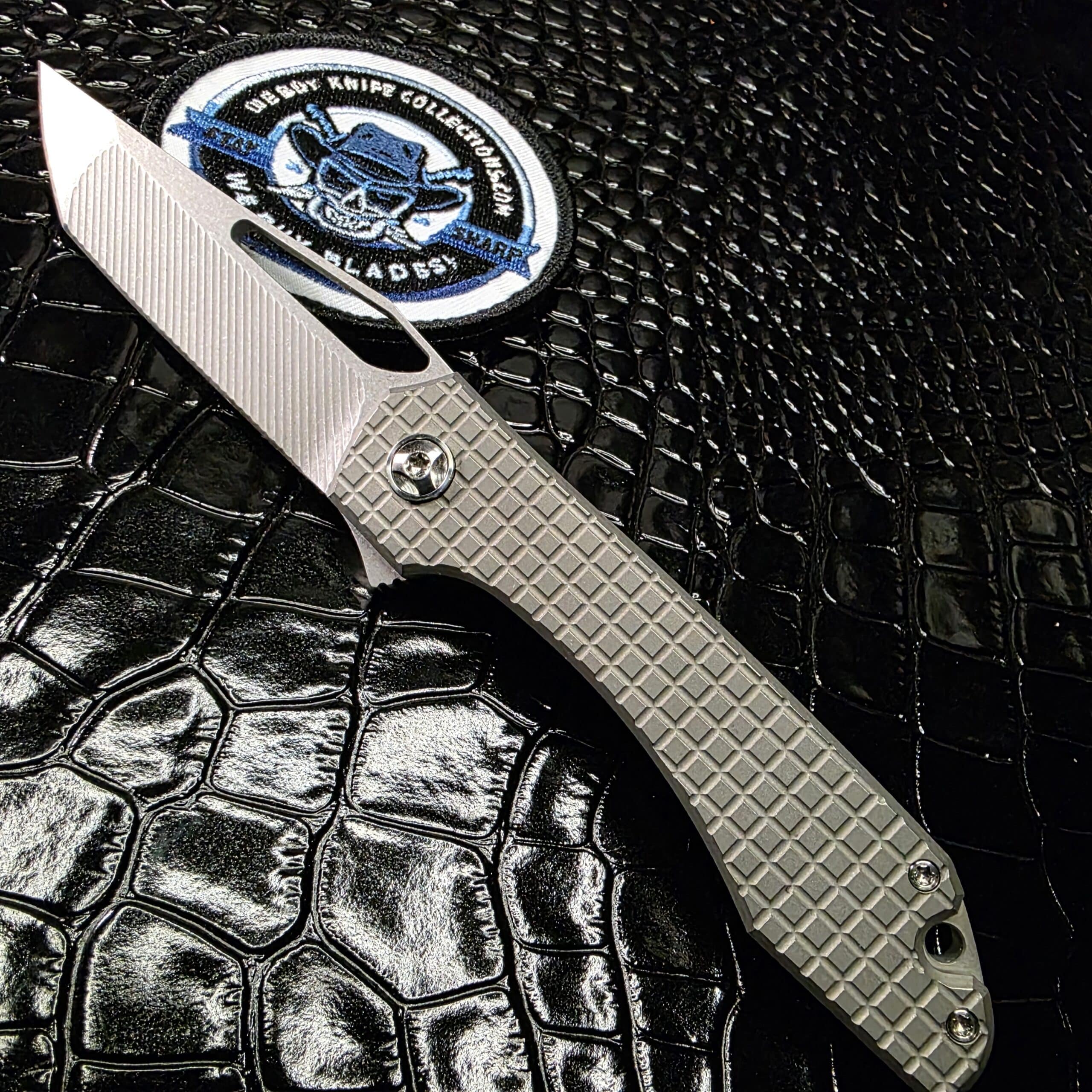 Simeon Custom Knives UnTo open showing 3.4 inch tumbled CPM154 blade and frag titanium handles