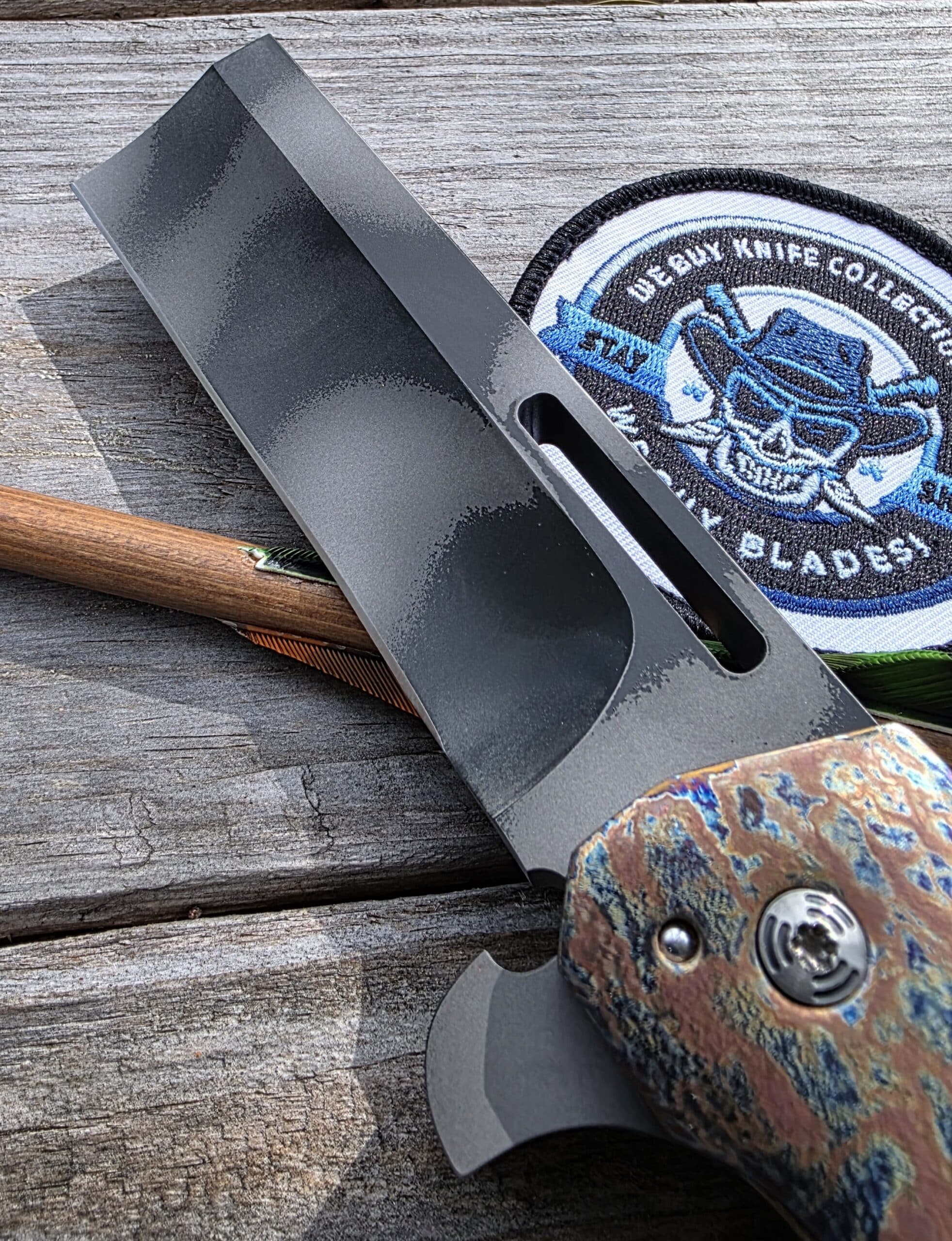 Macro view of the Wharncliffe razor tip on a Reese Weiland Custom Fatty Slasher Flipper.