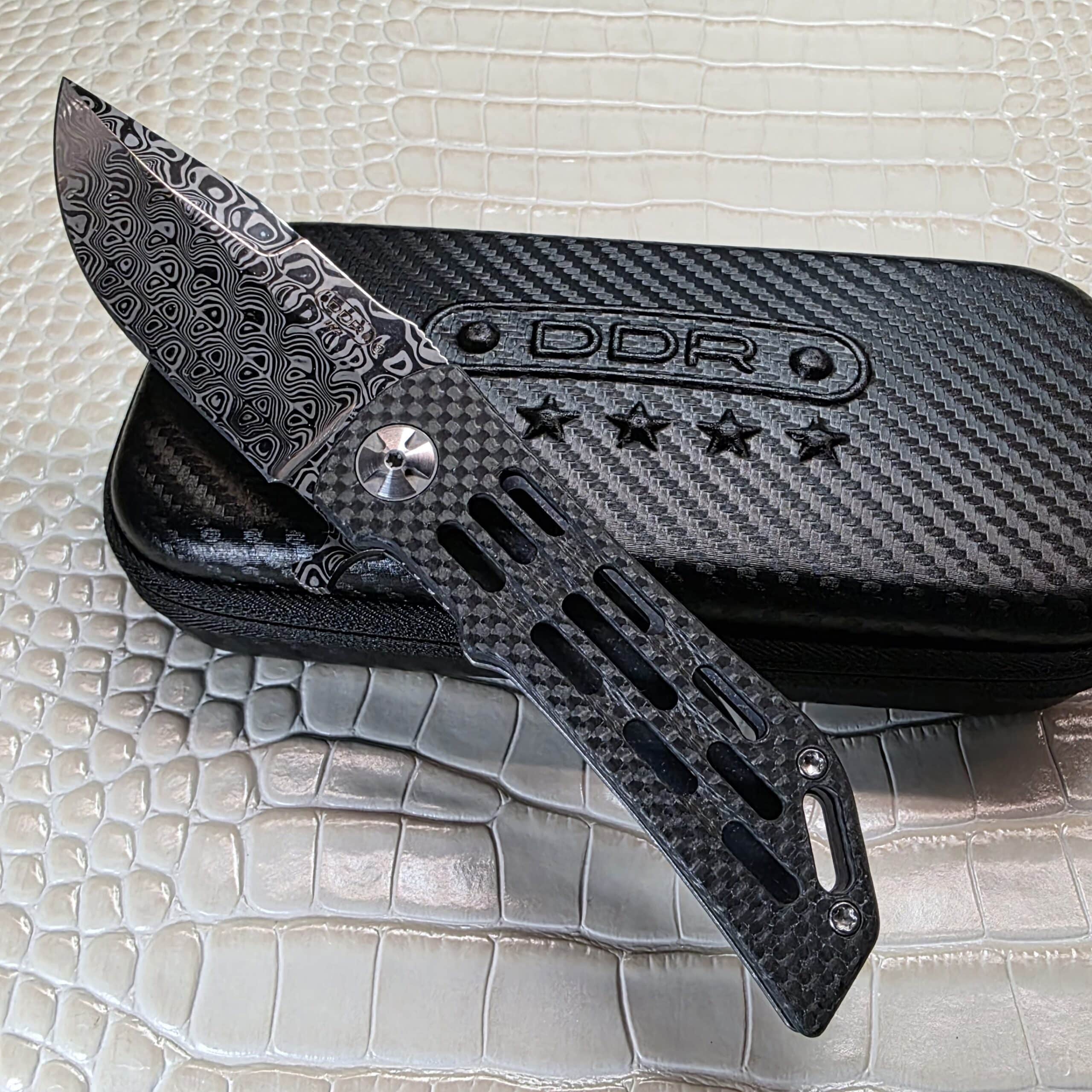 Darrel Ralph Custom Dominator Ventilator 2 hero photo showing Damasteel blade and ventilated carbon fiber show side