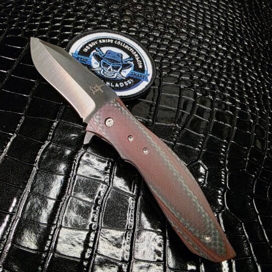 Greg Lightfoot Custom Bullwhip folding knife with red carbon fiber handle and CPM 154 steel blade.