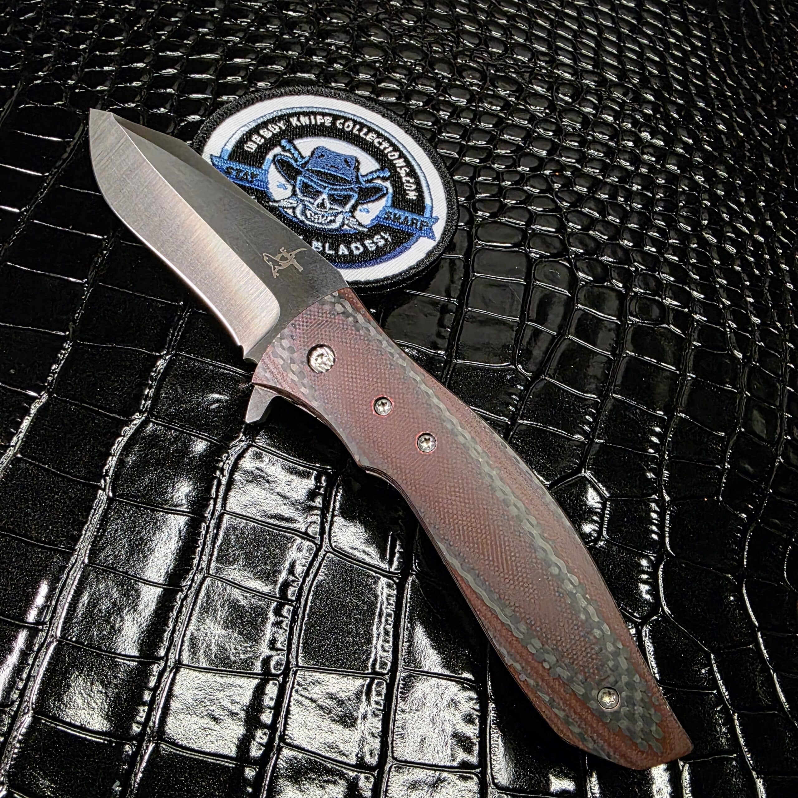 Greg Lightfoot Custom Bullwhip folding knife with red carbon fiber handle and CPM 154 steel blade.