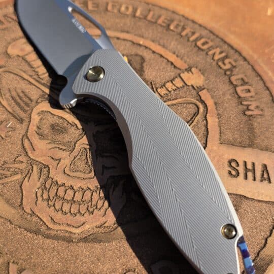 Koenig Knives Arius custom flipper knife with pattern milled titanium handles and Timascus upgrades.