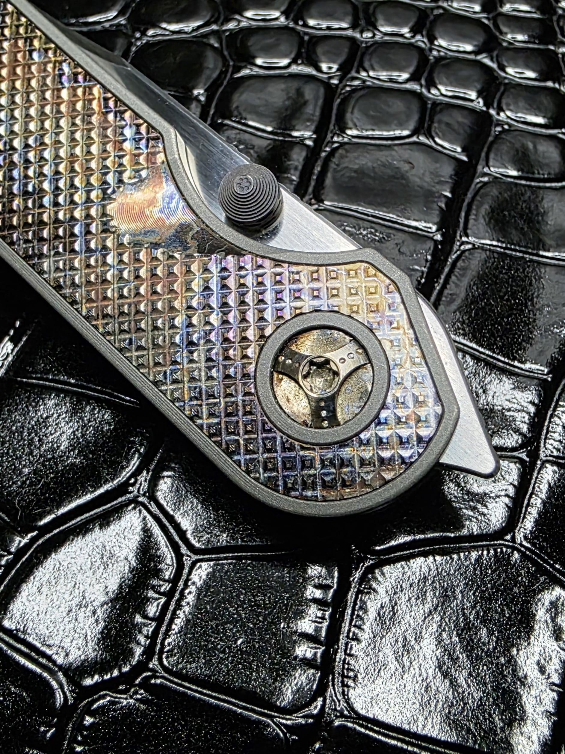 Close-up of the titanium pivot on a Hypercut Manufacturing Bikkhu.