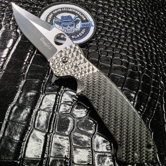 Crawford Knives Custom Kasper Flipper with carbon fiber scales and jeweled titanium bolsters.