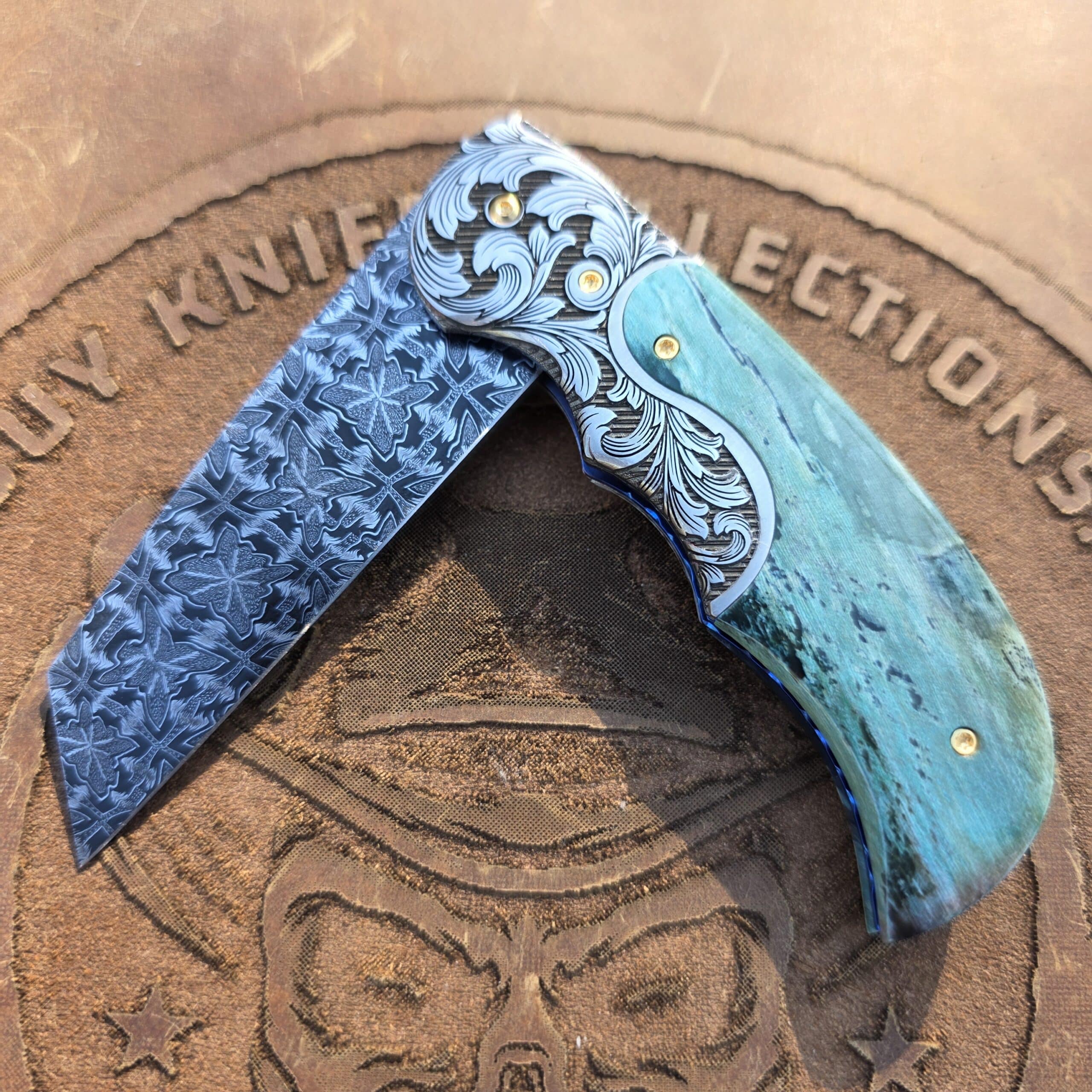 Presentation side of the Curt Zimmermann folder highlighting the 3-inch Butterfly Damascus blade.