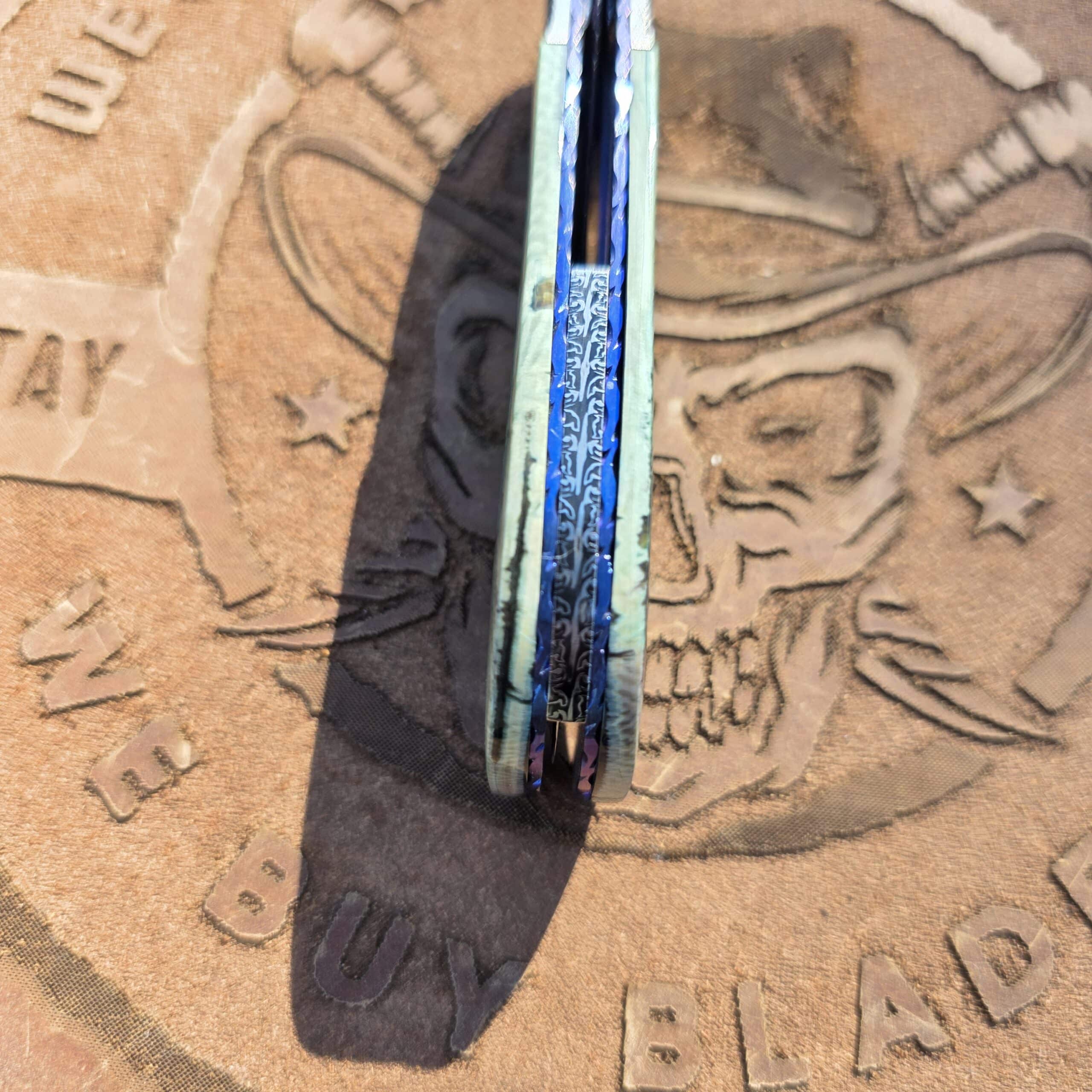 Top-down view of the Zimmermann folder spine showing the Damascus backspacer.
