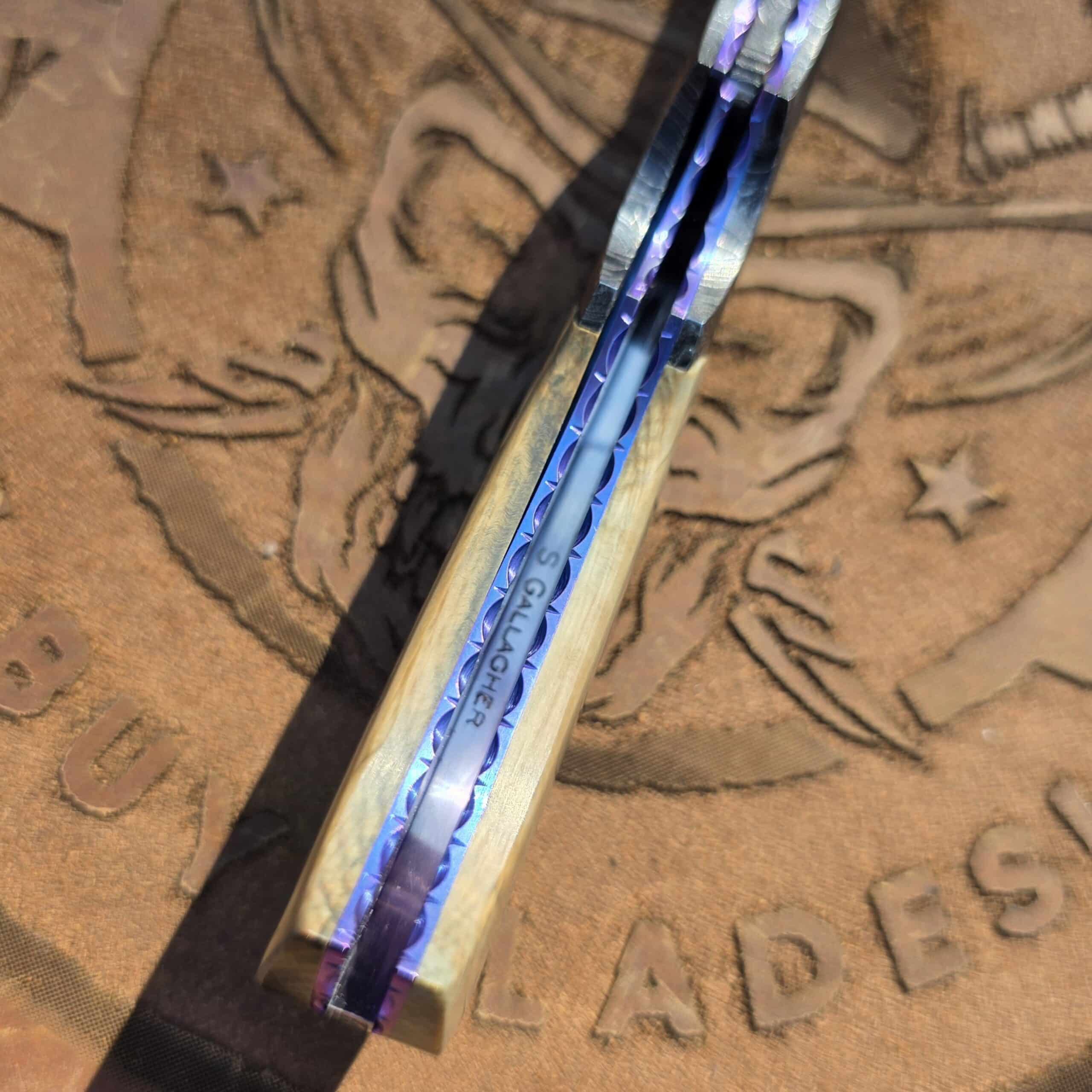 Engraved and anodized titanium liners on a Scott Gallagher custom knife.