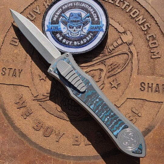 Hawk Deadlock Model C OTF knife with Blue Carbon Fiber inlays showing zero blade play lockup. The John Wick knife.