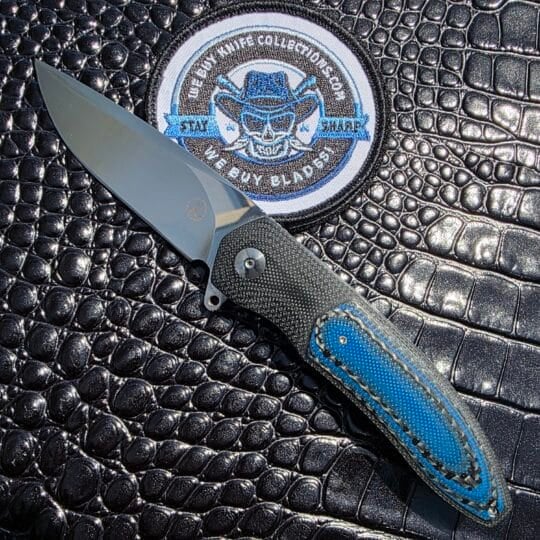 The Keith Kruger Custom K4 Interframe Flipper with blue and black carbon fiber inlays shown in a full show-side profile.