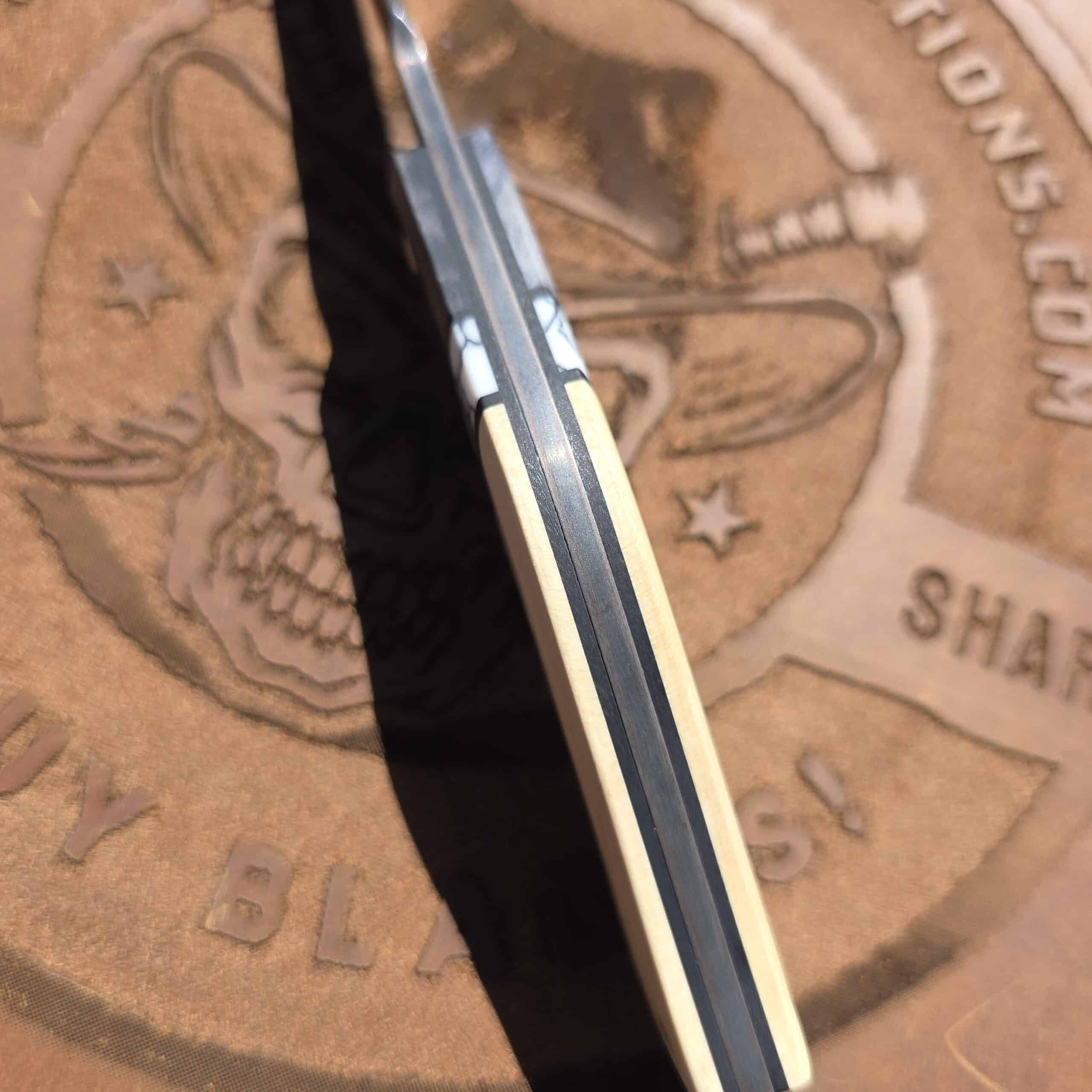 Spine of the E.F. Maldonado fixed blade showing the copper layers and distal taper.