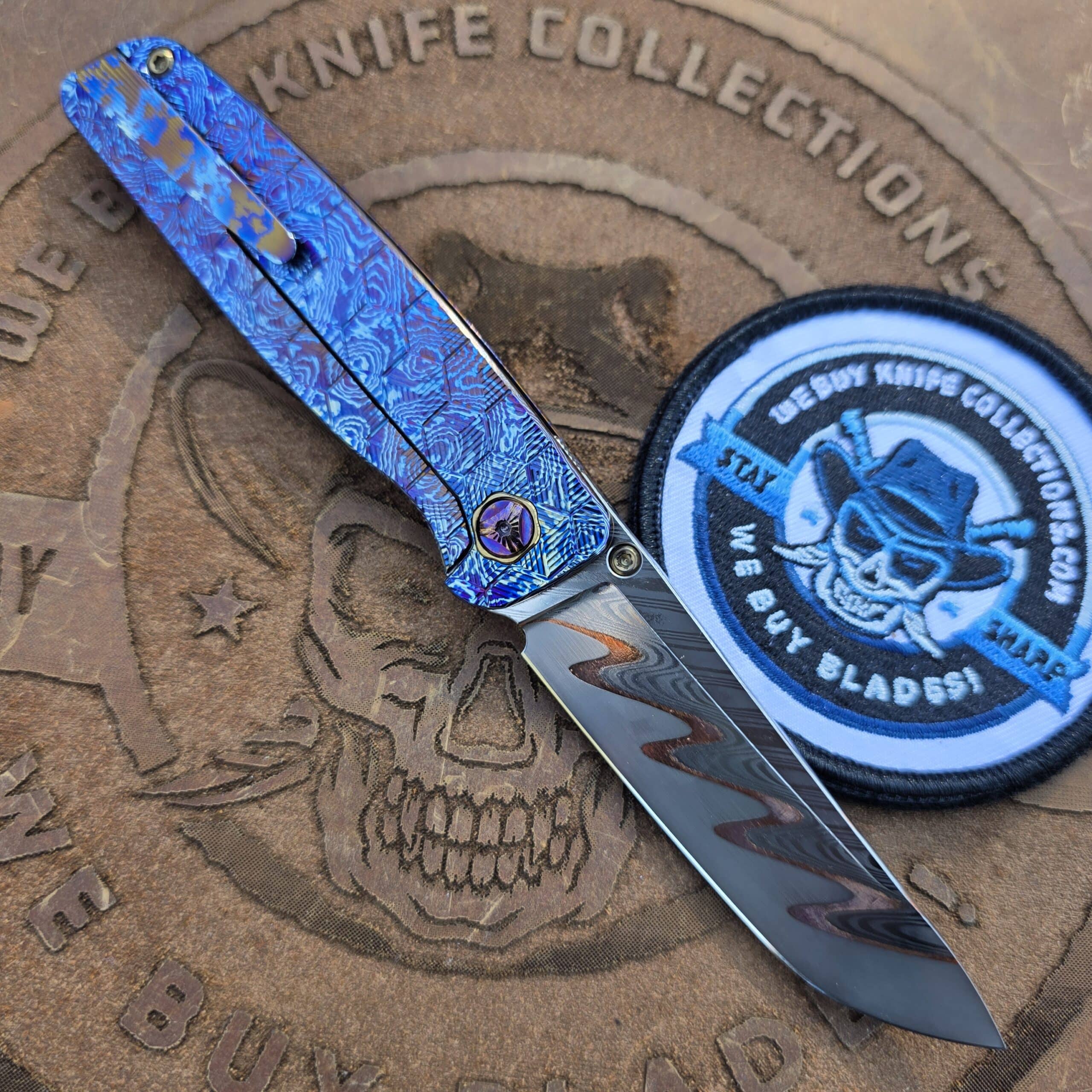 The reverse side of the Robjohnsons Cypress V3 custom folder, open to show the milled Timascus pocket clip, frame lock mechanism, and Gold Titanium hardware.