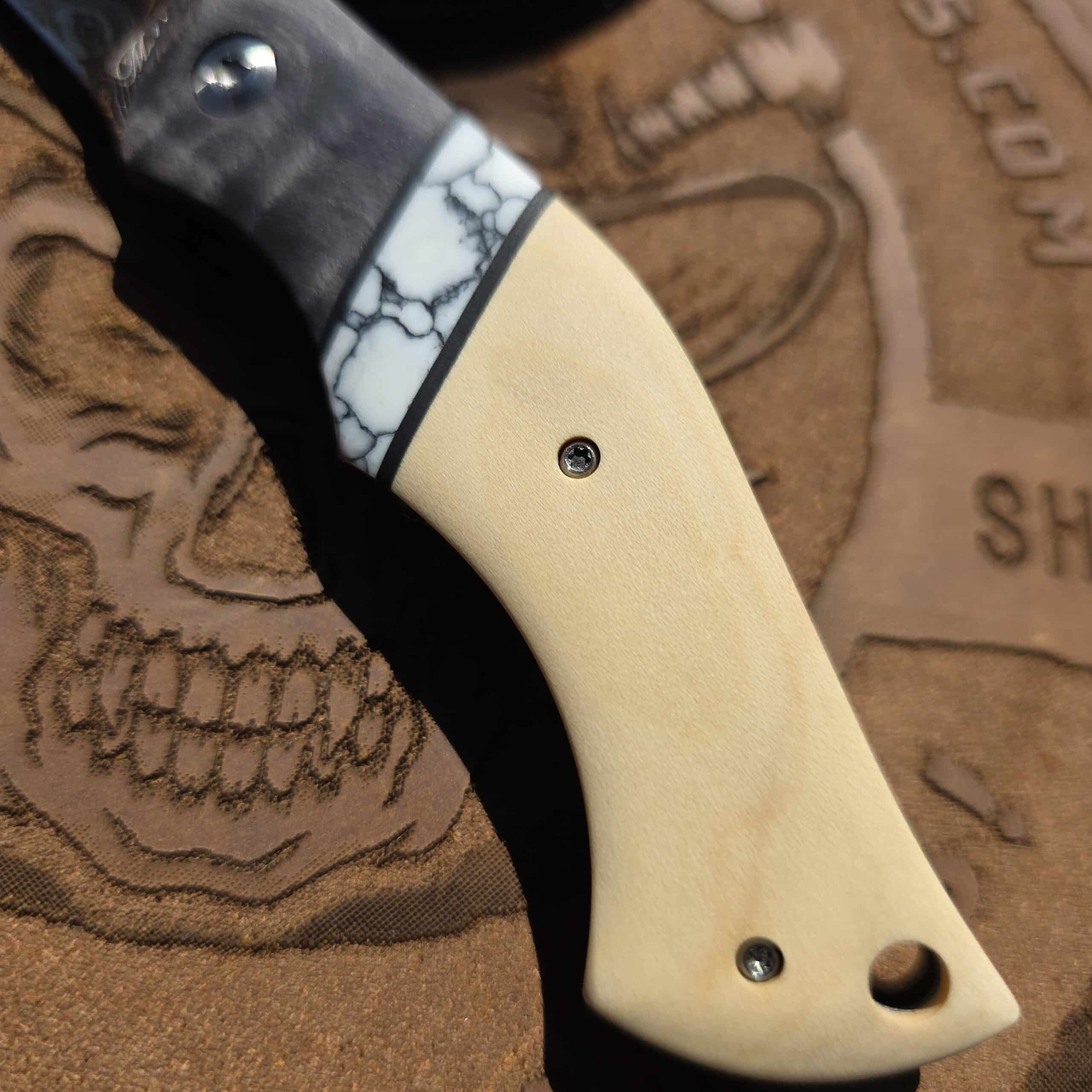 Close-up of the segmented handle scales by Robs Wildwood on a Maldonado custom knife.