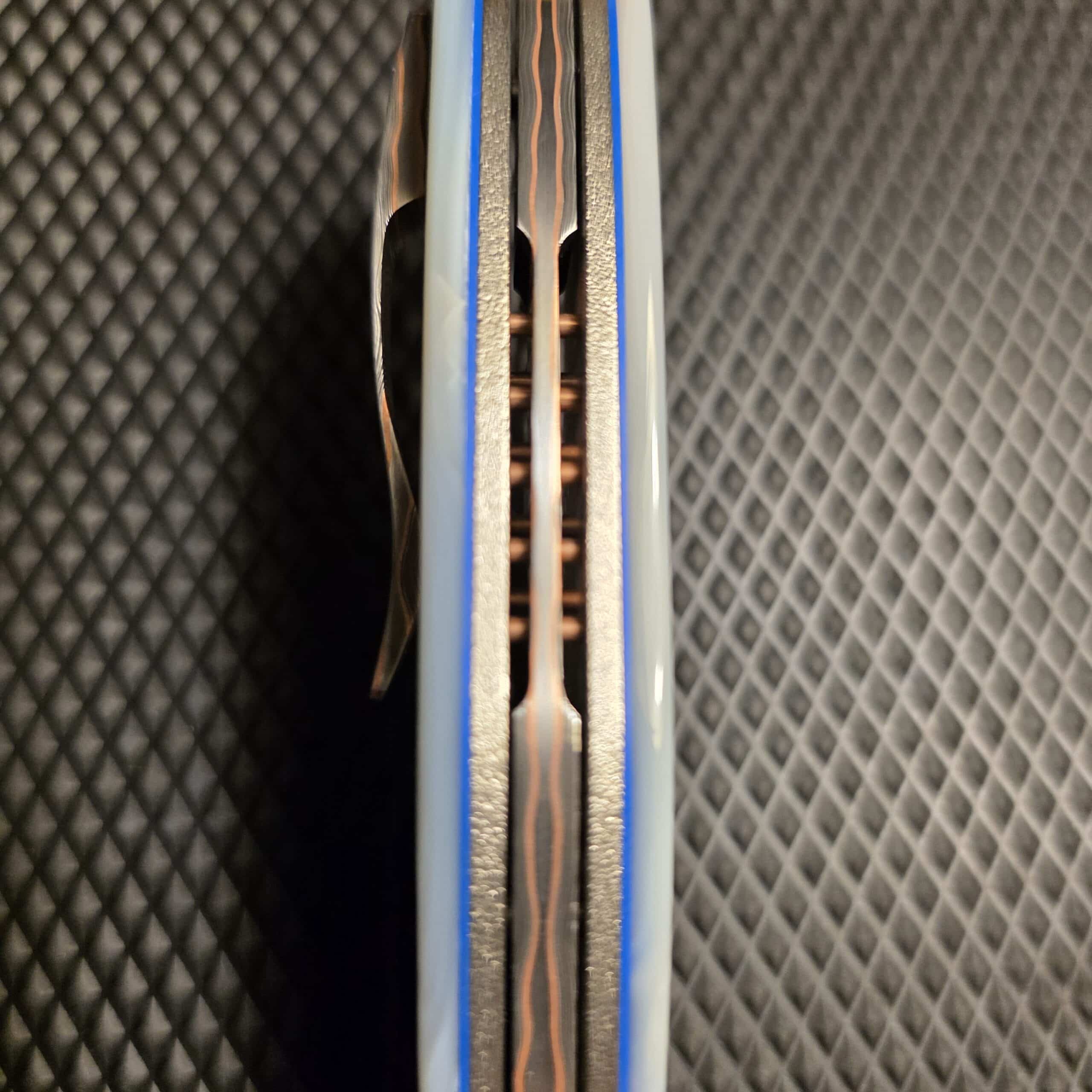 Top-down view of the Shane P. Atwood Vengeance spine showing textured titanium and backspacer.