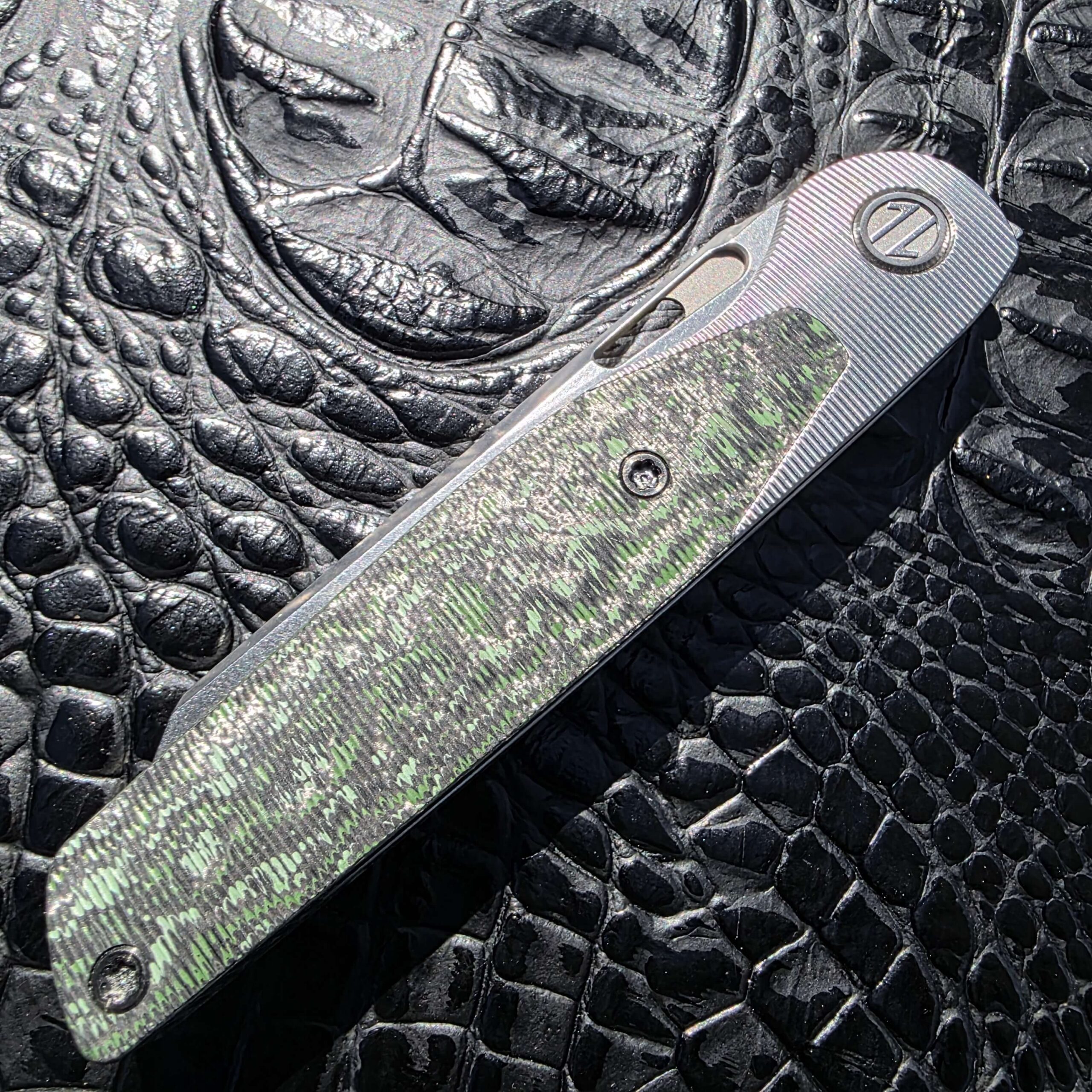 Secondary hero image of Brown Knives Cortex V2 #329 highlighting Jungle Wear inlay and vertical milling