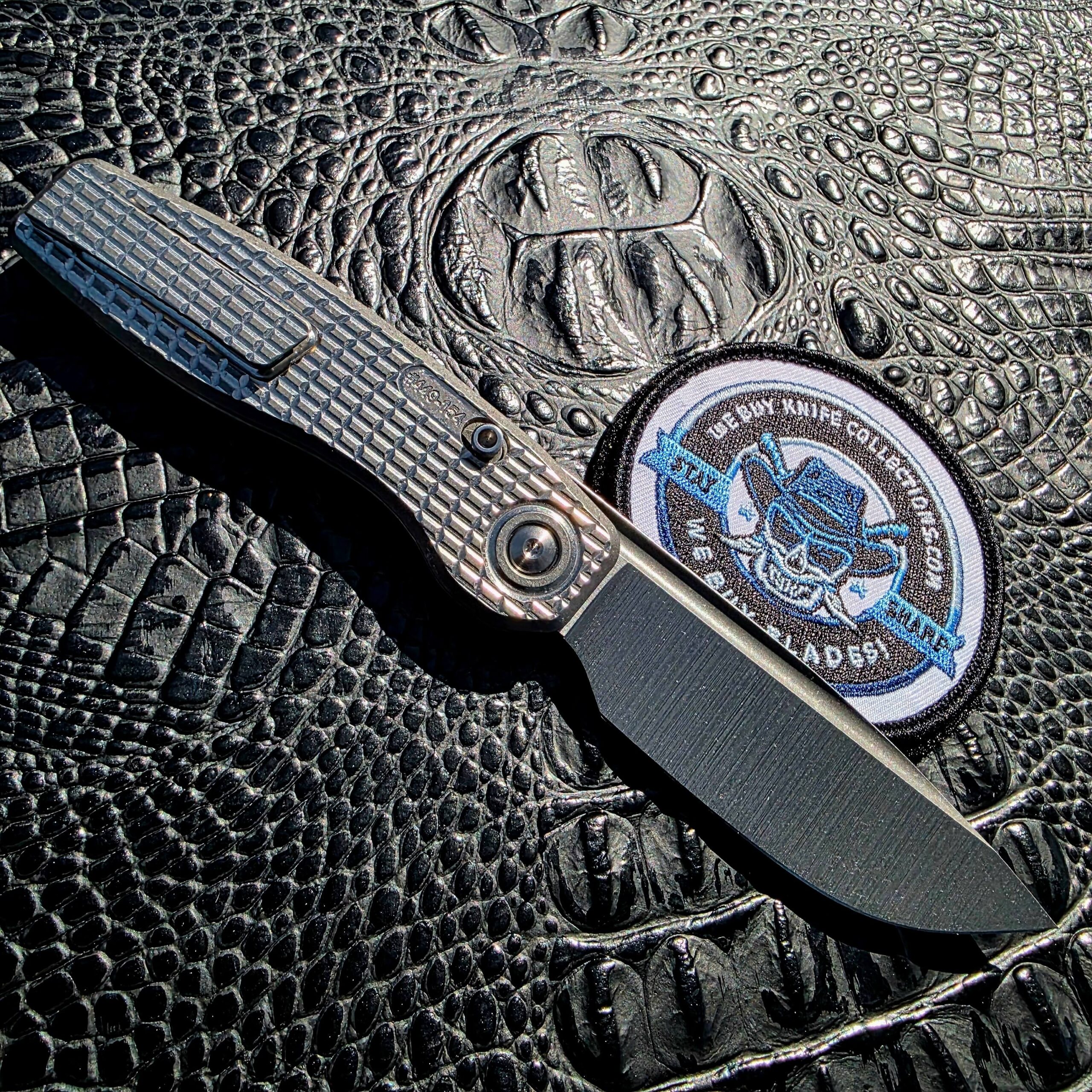 Open clip-side view of Brown Knives Mini FSD #449 with titanium pocket clip