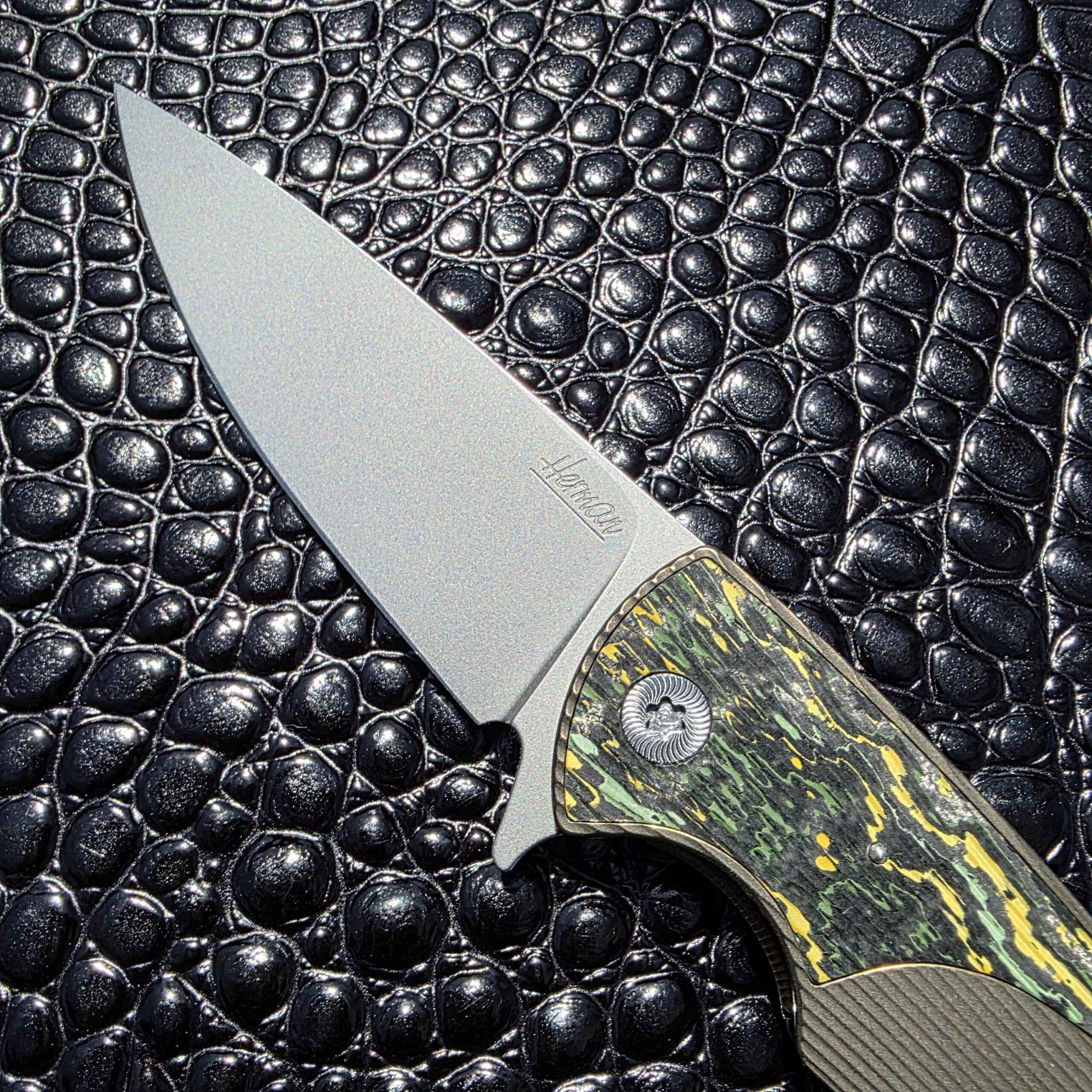 Close-up of tumbled M390 blade on Herman Knives Sting Flipper