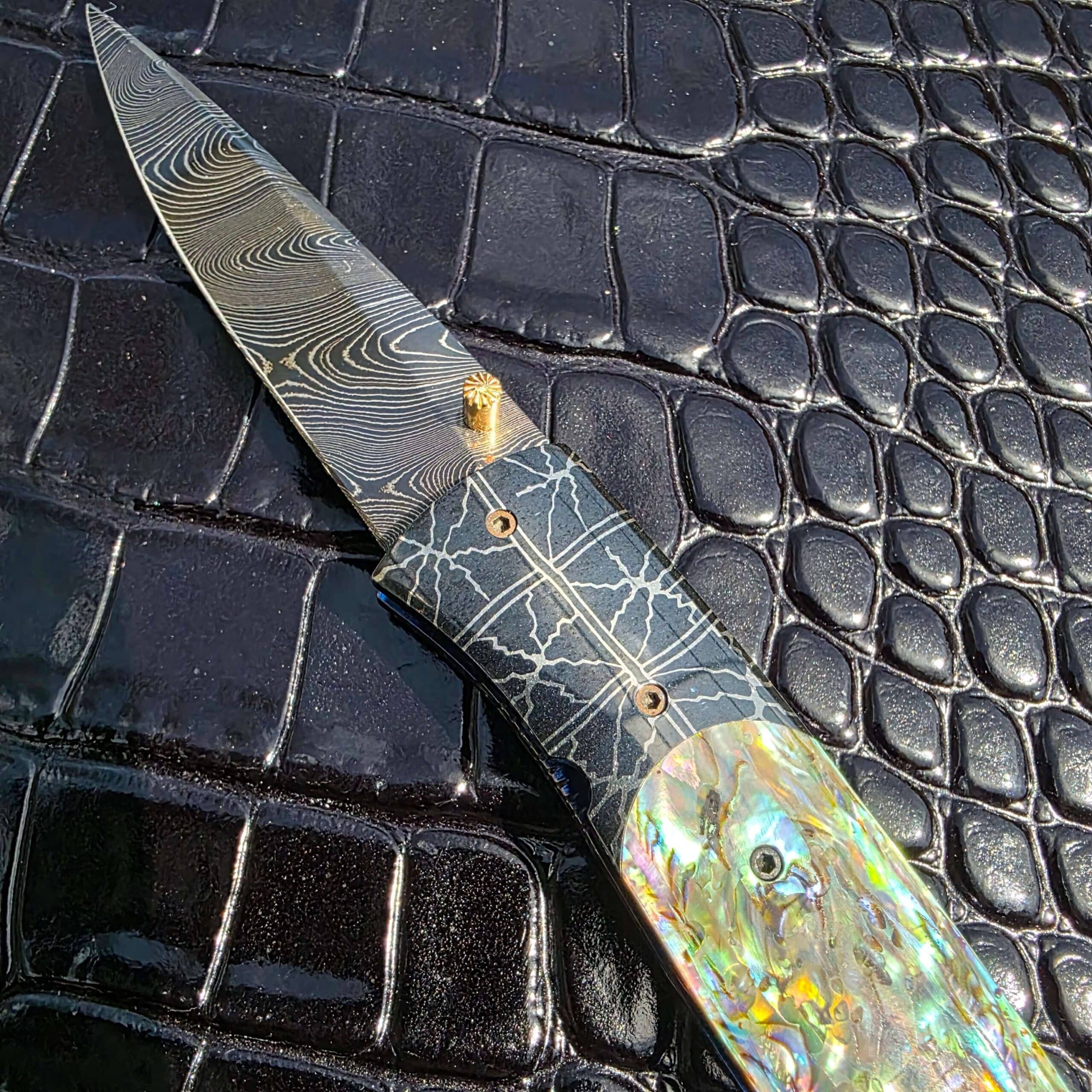 Open show-side view of Jeff Chaffee custom linerlock with blued Damascus blade