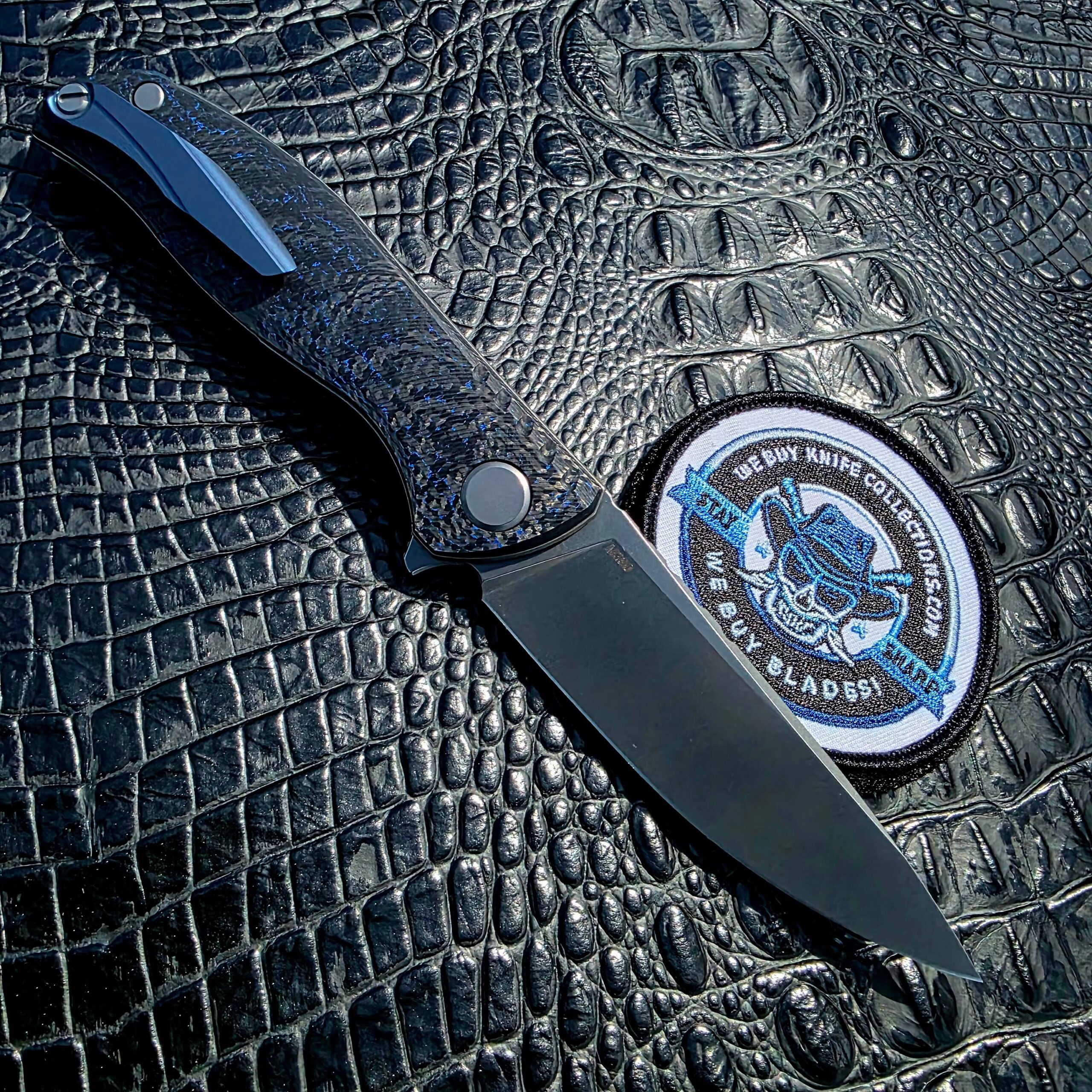 Open clip-side view of Shirogorov F3 NS with blue anodized titanium clip