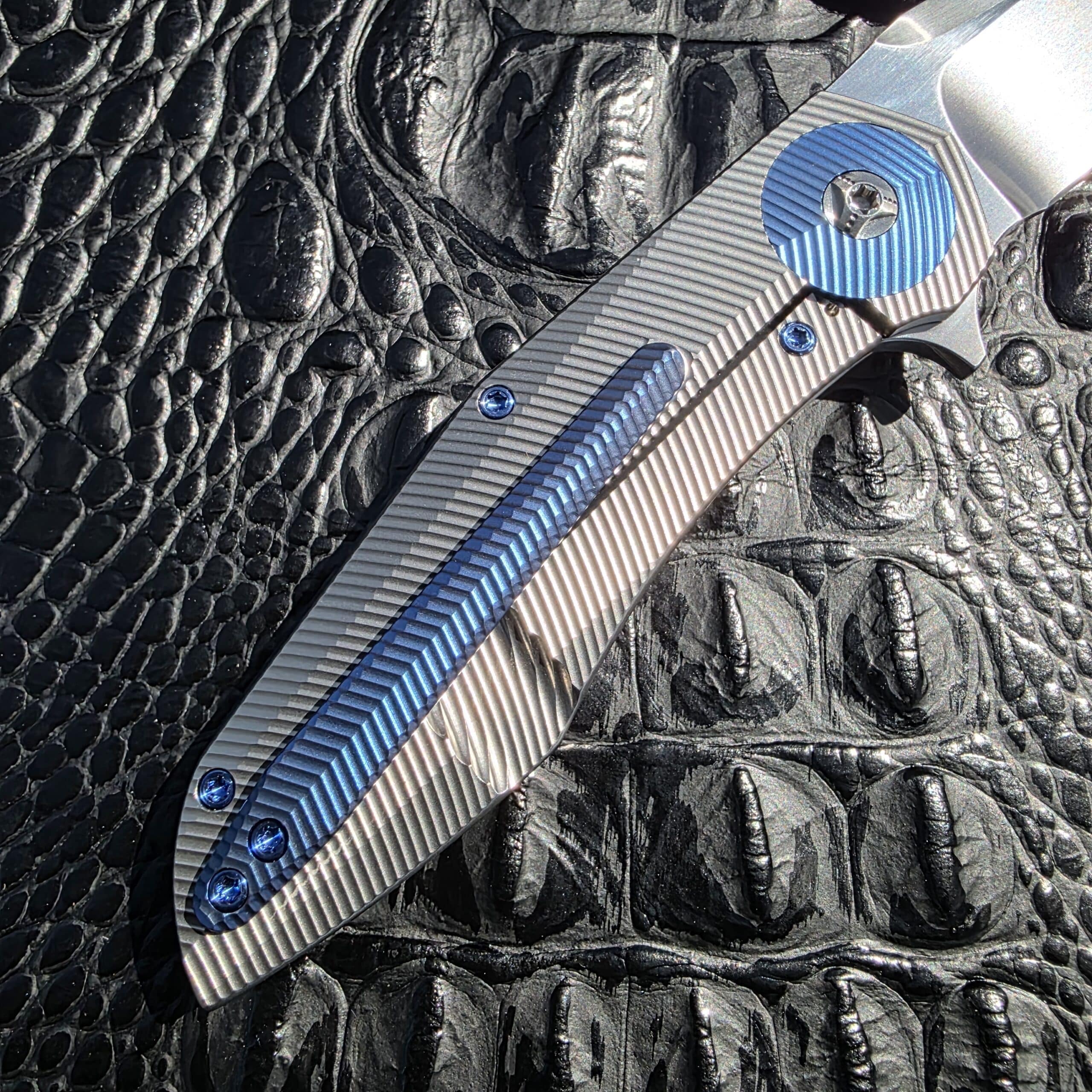 Blue anodized titanium hardware detail on Skiff Made Blades Culprit