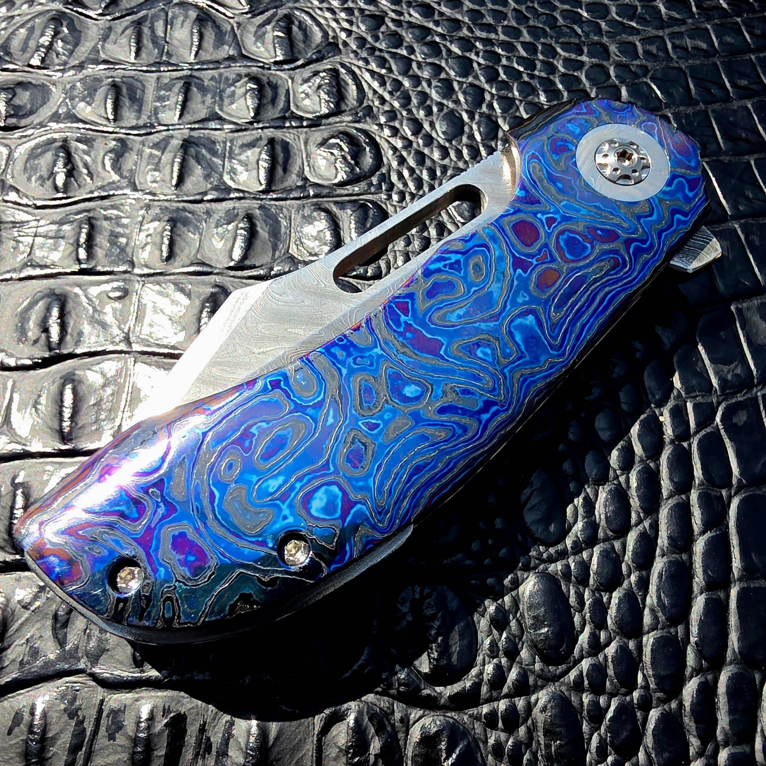 Closed show-side view of Clark Blades Patriot with Black Timascus scales