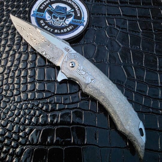 De Kock NS Linerlock with Damasteel blade and Crystal Titanium scales Image Title: Jaco De Kock NS Linerlock Hero