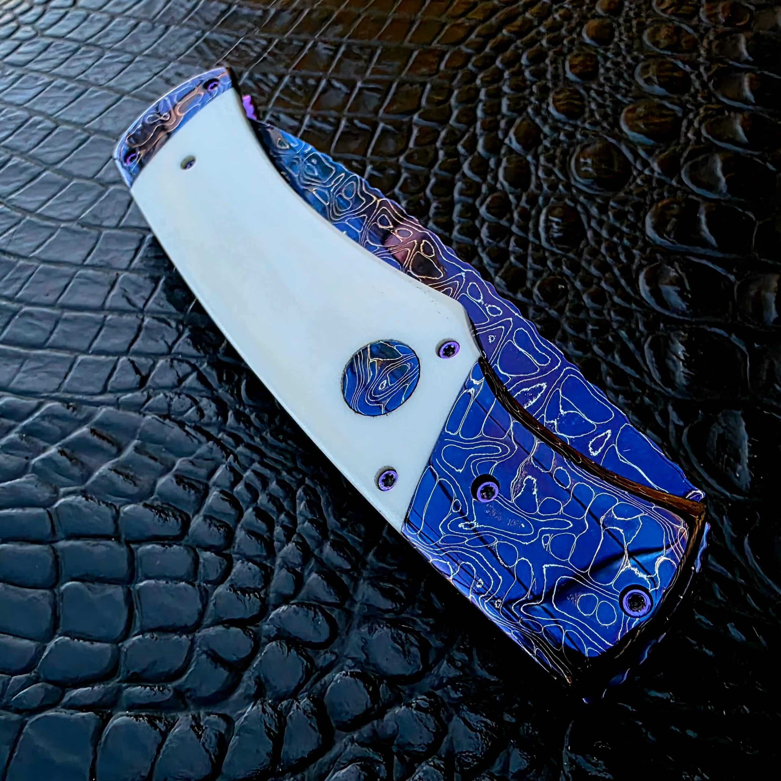 Closed show-side view of Rainy Vallotton Custom Hunter with white linen Micarta