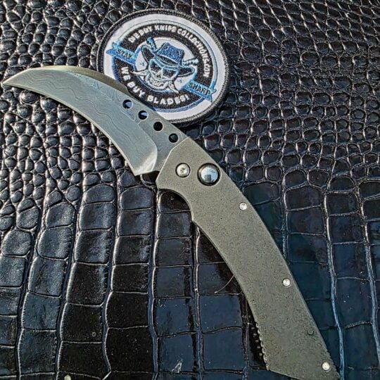 Text: Reese Weiland Custom Hawk Gen II automatic with custom Damascus hawkbill blade