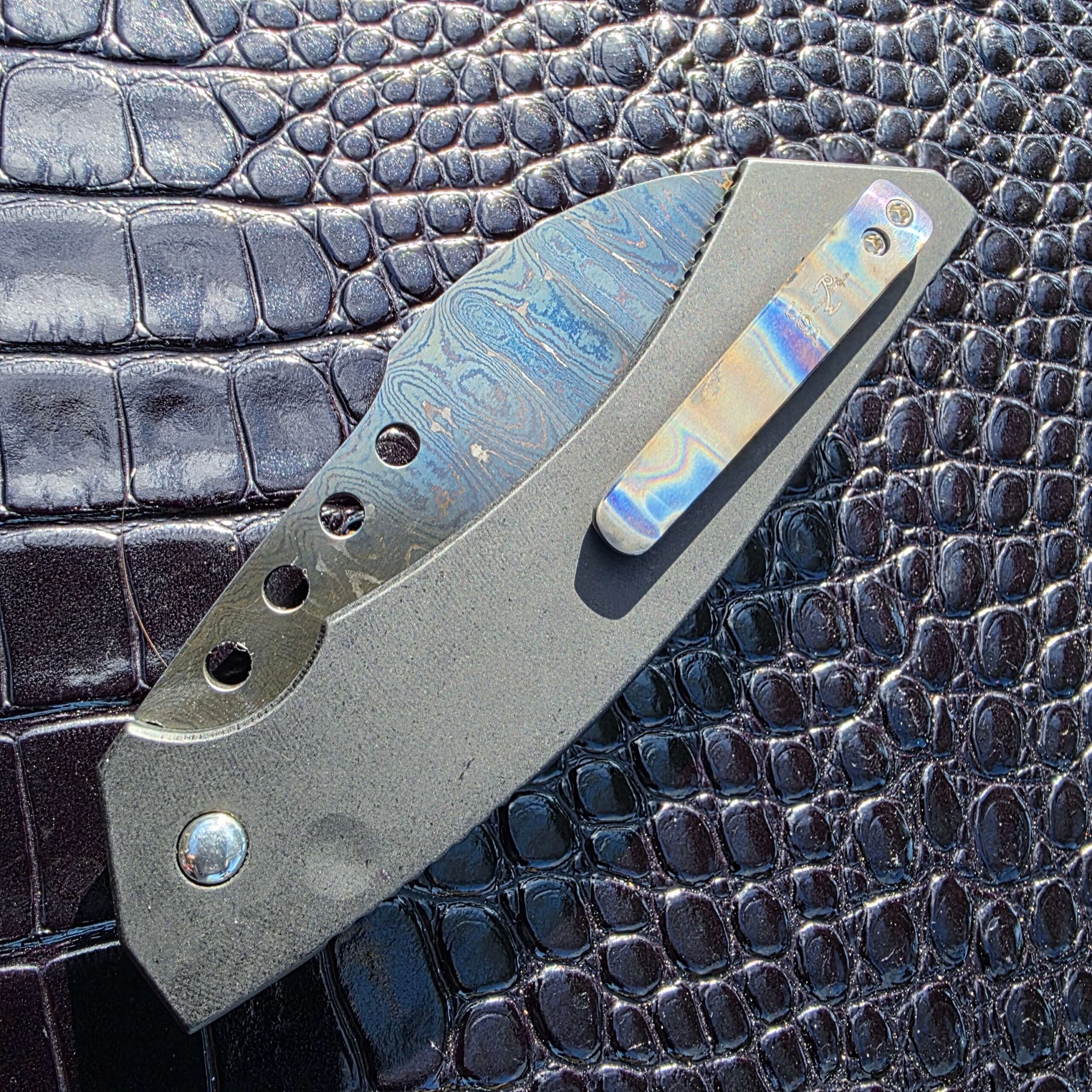Closed clip-side view of Reese Weiland Hawk Gen II with flamed titanium pocket clip