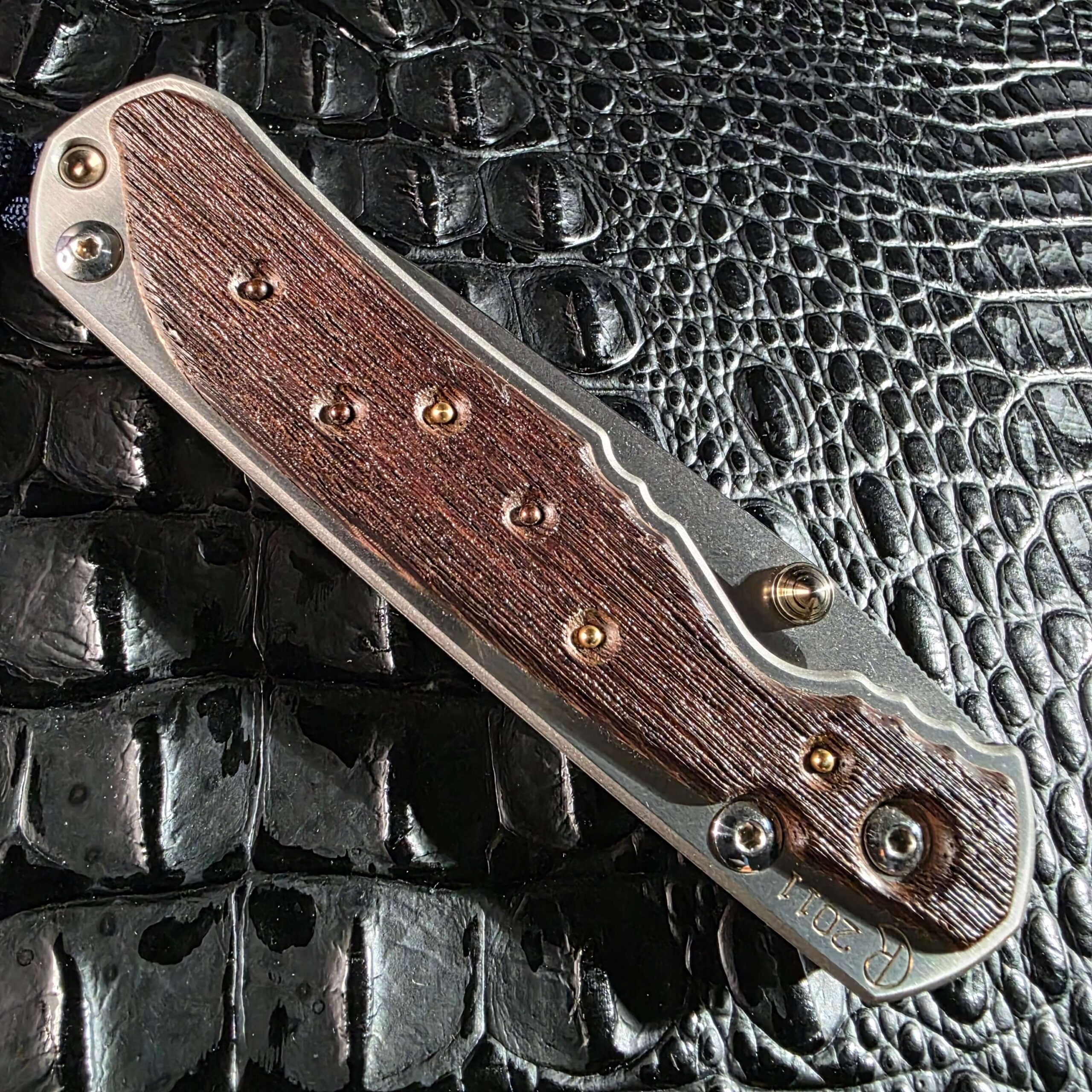 Closed Chris Reeve Large Sebenza 2011 Edition showing wenge inlay with gold and silver dots