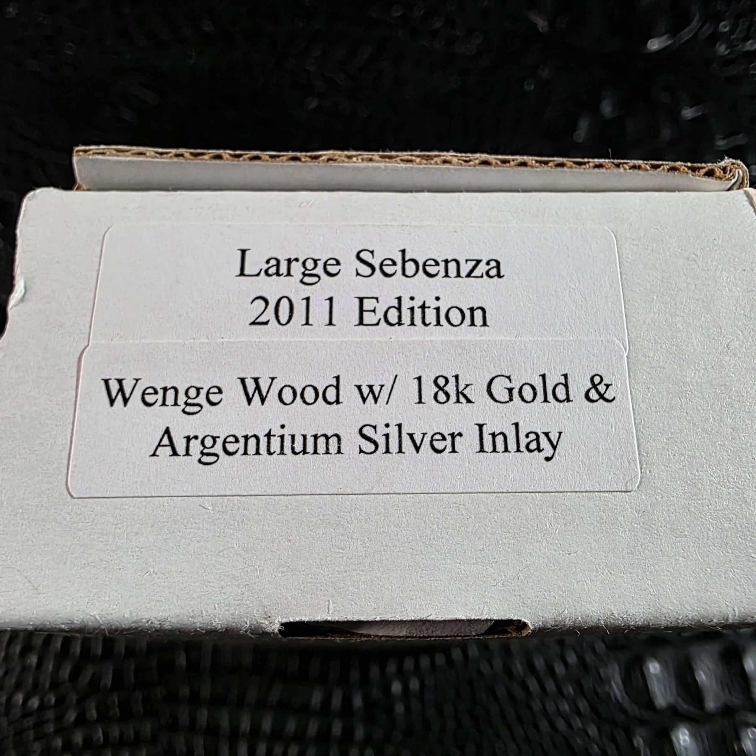 Chris Reeve box label reading Large Sebenza 2011 Edition Wenge Wood with 18k Gold and Argentium Silver Inlay
