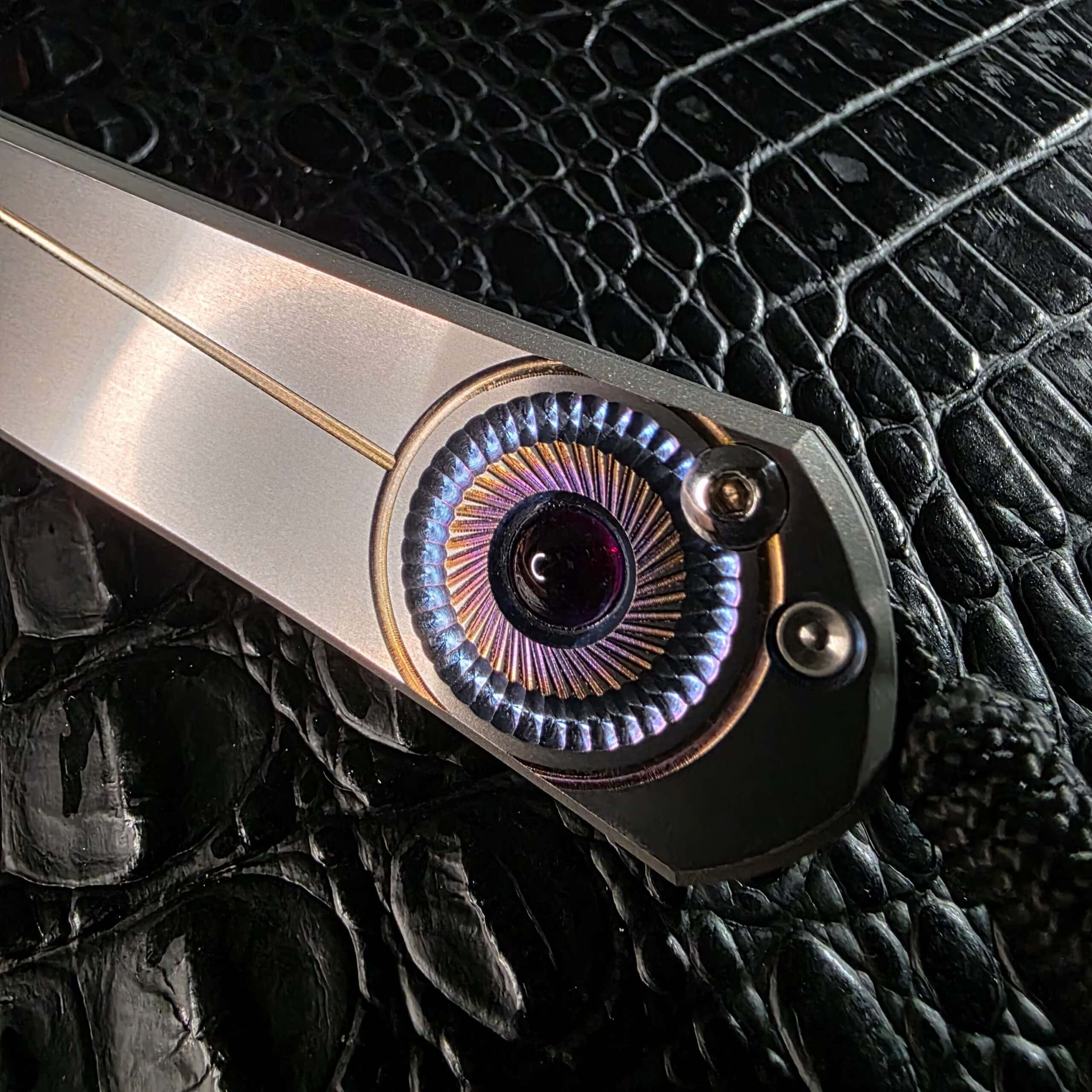 Polished amethyst cabochon set in Chris Reeve Sebenza 21 titanium handle