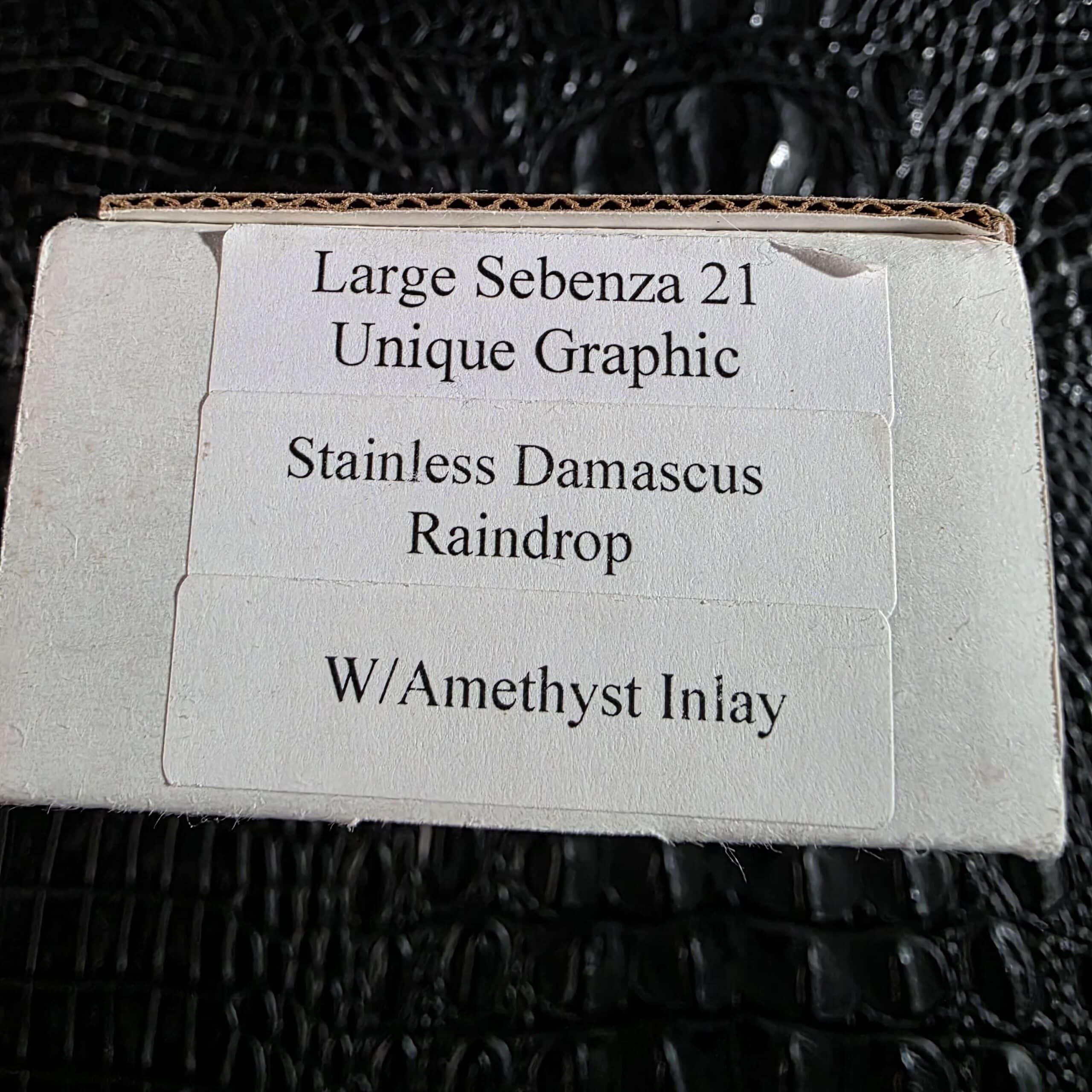 Chris Reeve box label reading Large Sebenza 21 Unique Graphic Stainless Damascus Raindrop