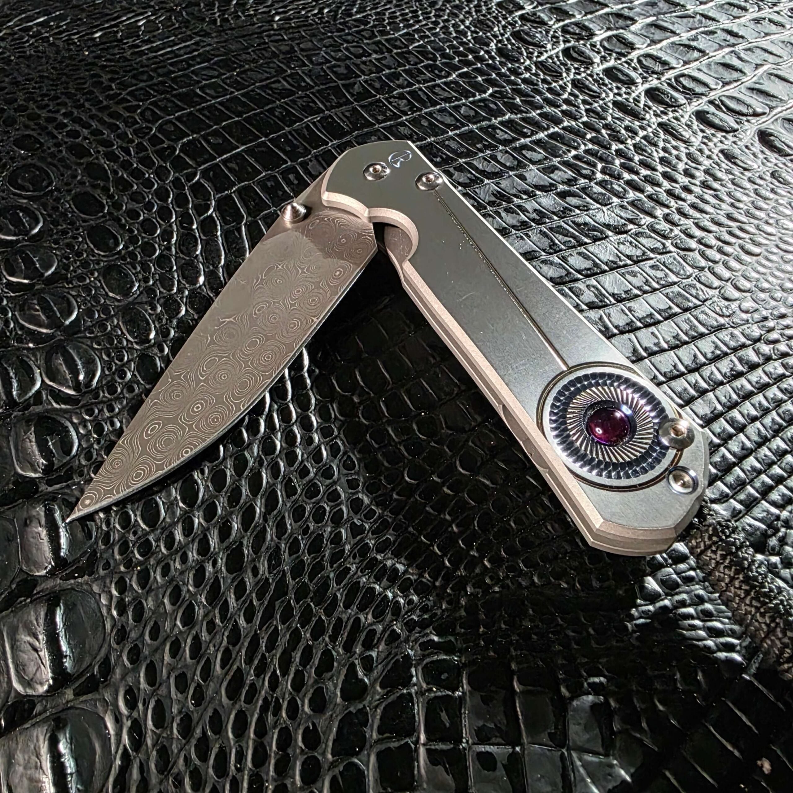 Chris Reeve Sebenza 21 Damascus blade partially open showing washer action