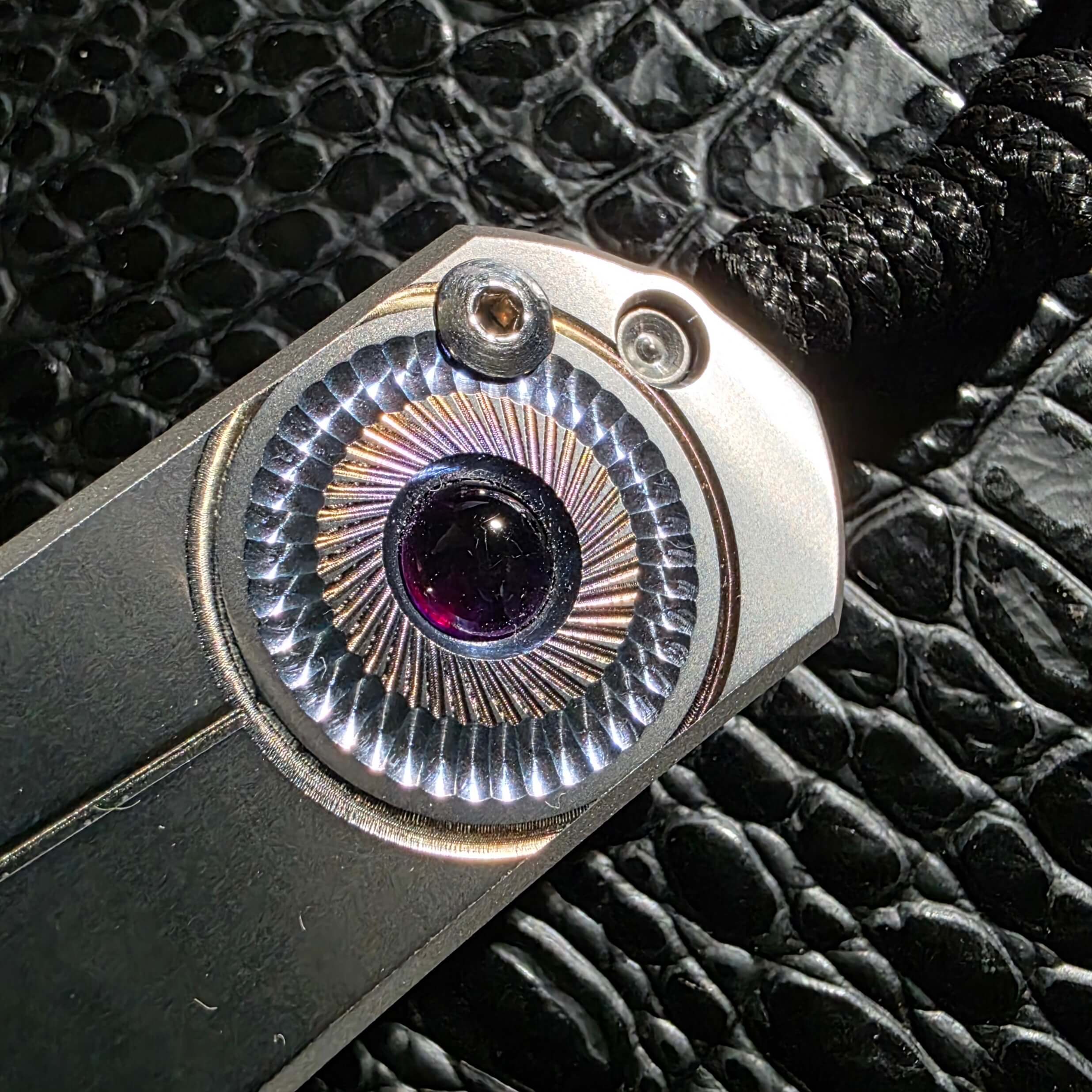Hand-milled turbine sunburst graphic on Chris Reeve Sebenza 21 titanium scale