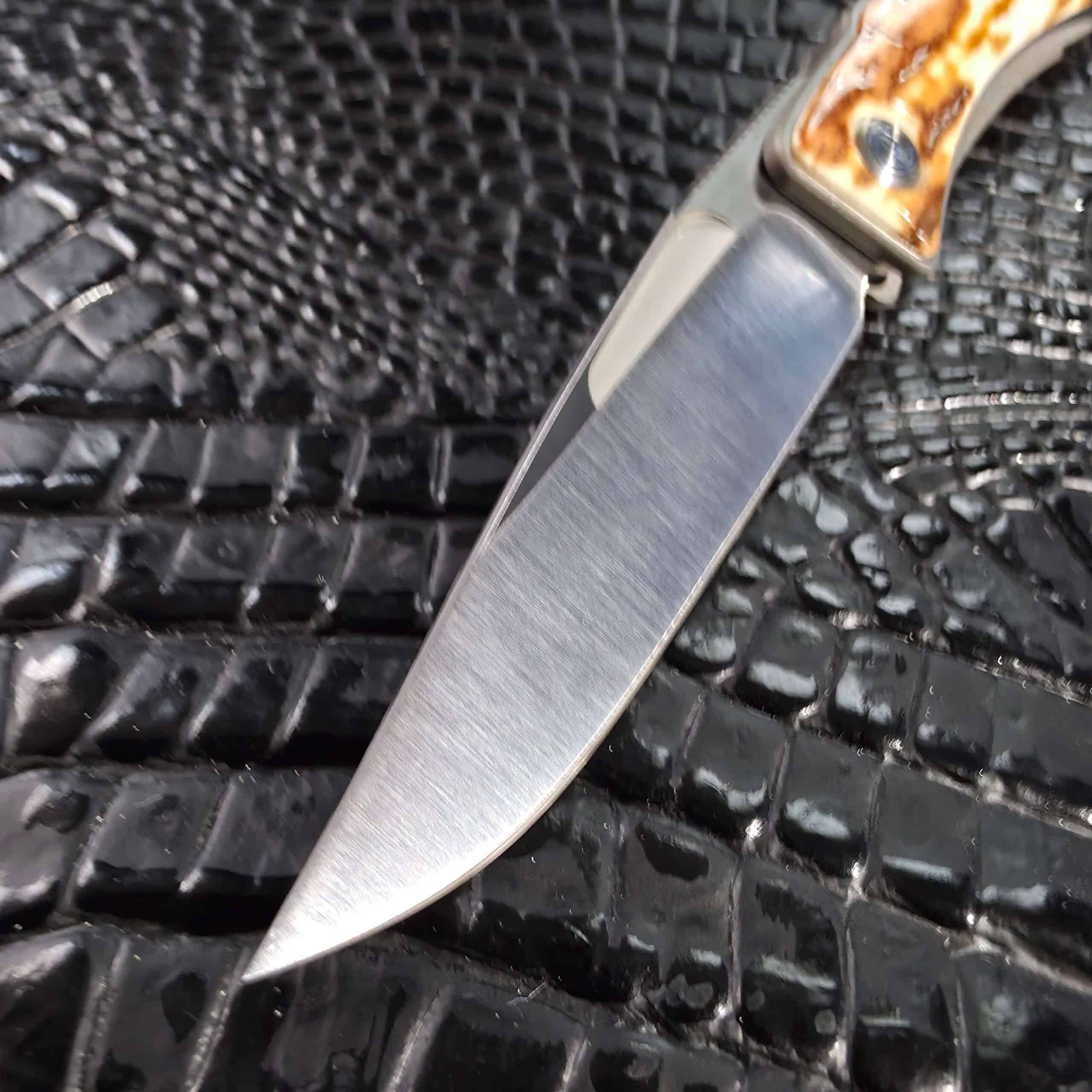 Hand-satin S30V blade with flat hollow grind on the Chris Reeve Mnandi