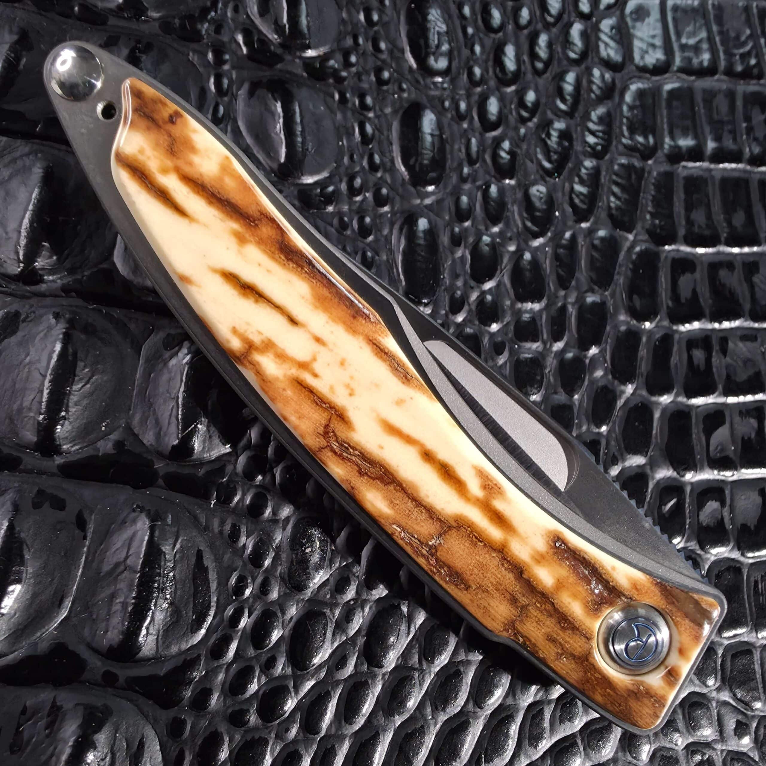 Closed Chris Reeve Mnandi showing full-length mammoth bark ivory inlay