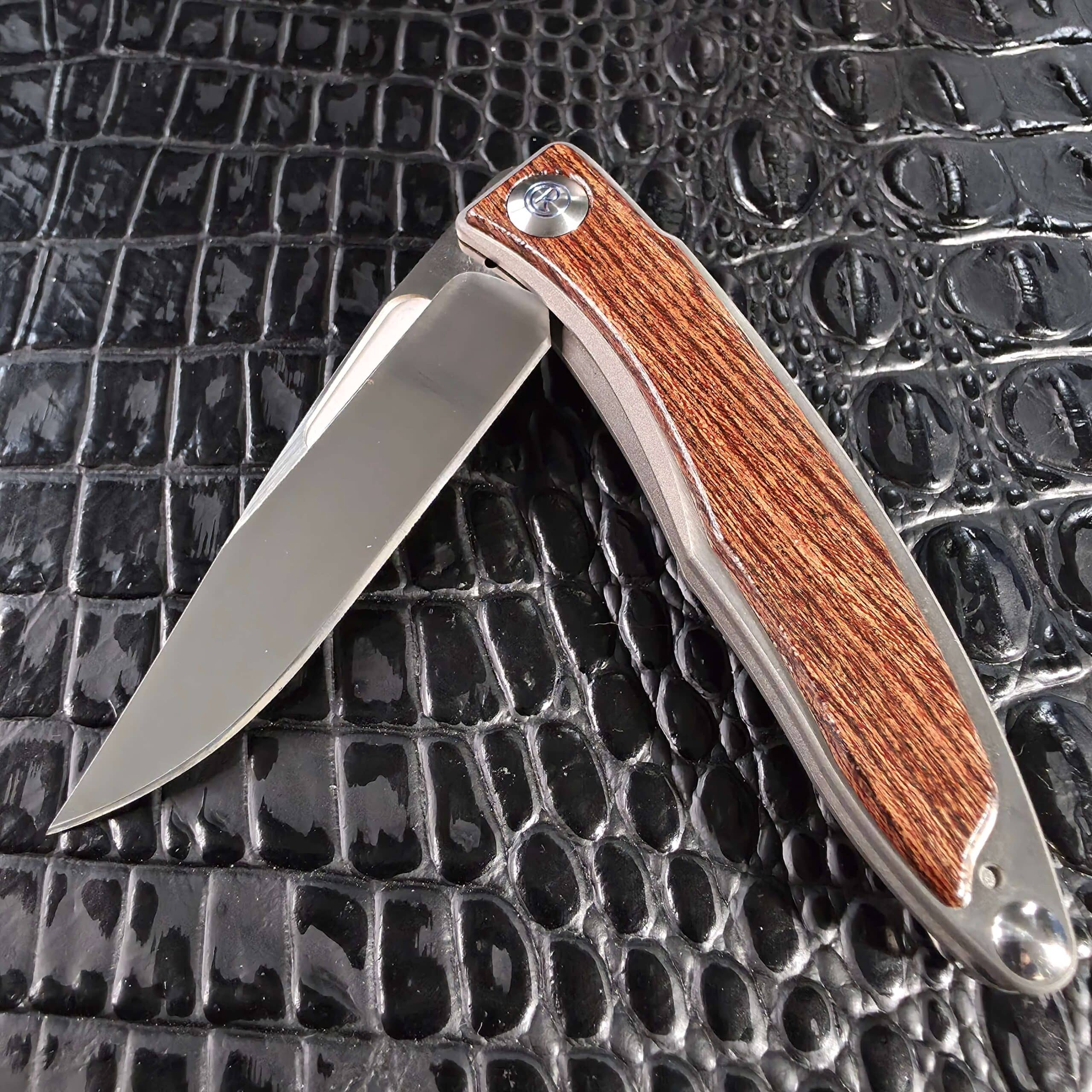 Chris Reeve Mnandi Bocote partially open showing the blade and titanium frame
