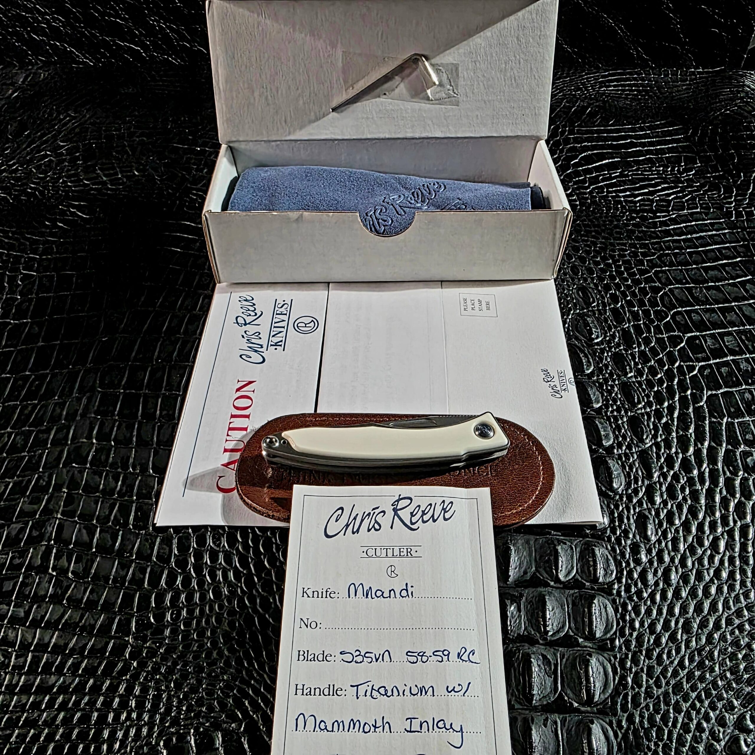 Chris Reeve Mnandi with complete original accessories including signed birth card, box, leather slip pouch, cleaning cloth, hex wrench, and caution insert