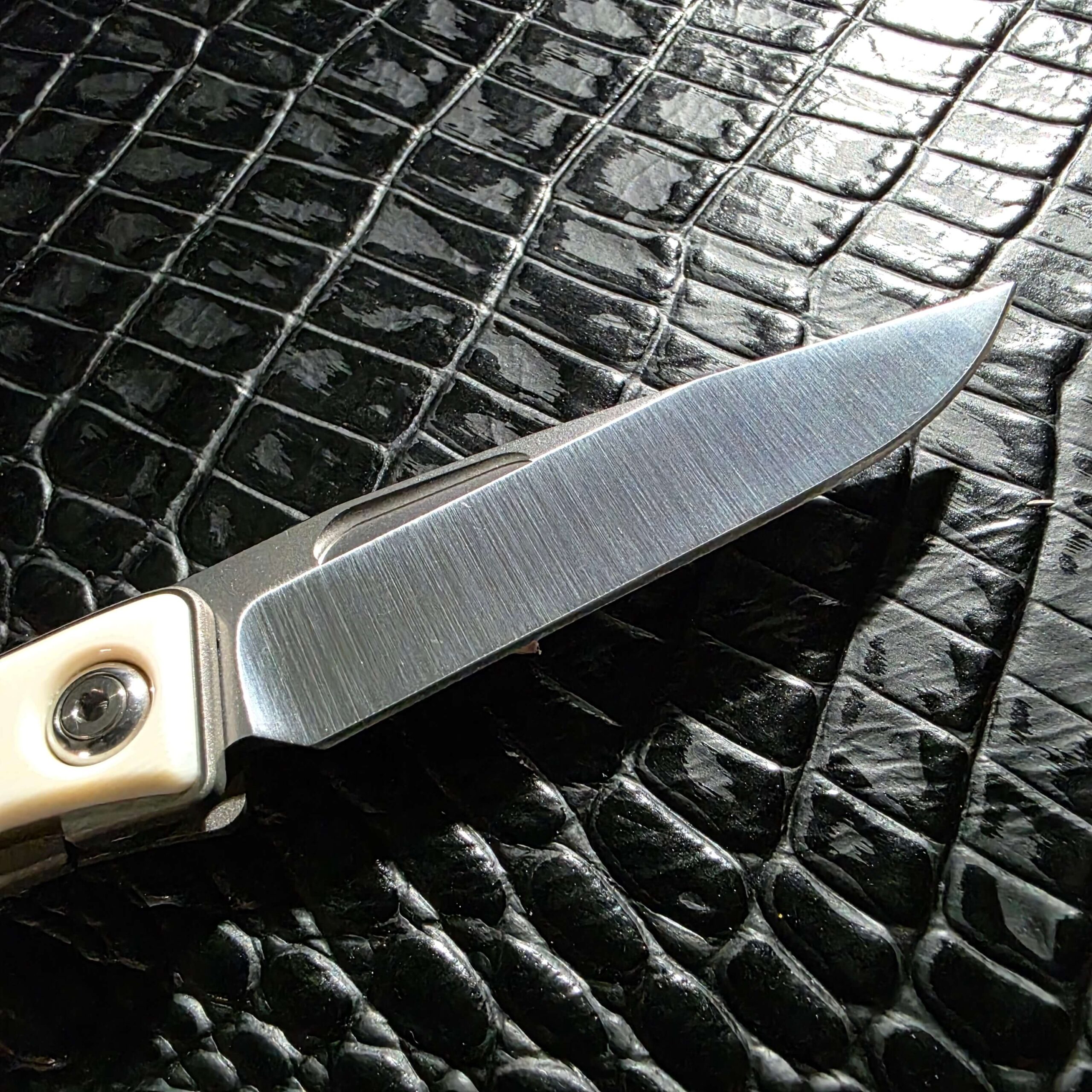 Hand-rubbed satin CPM S35VN blade on the Chris Reeve Mnandi showing the hollow grind and thumbnail recess
