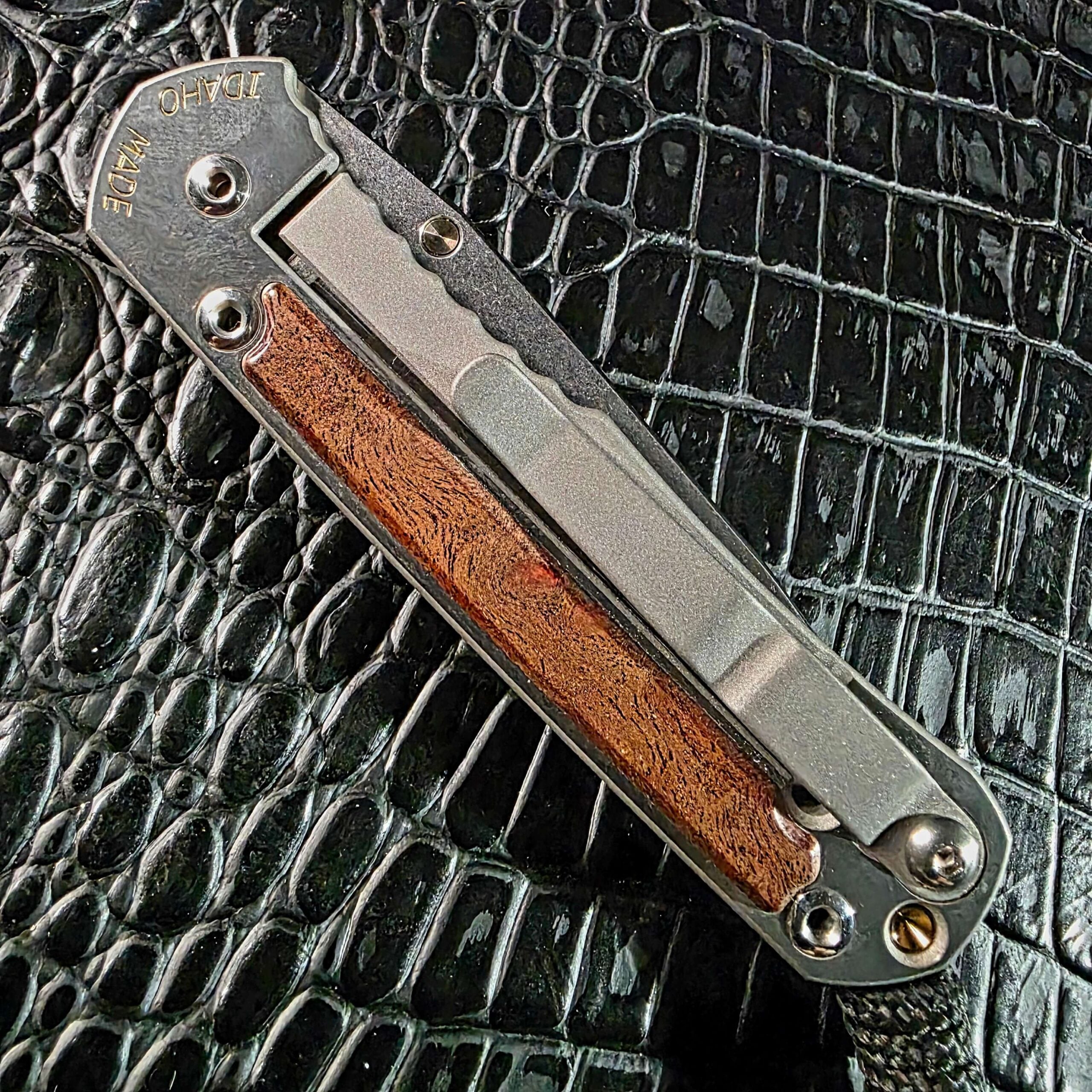 Closed lock side of the Chris Reeve Small Sebenza 2010 Annual with titanium pocket clip, Idaho Made engraving, and camphor inlay