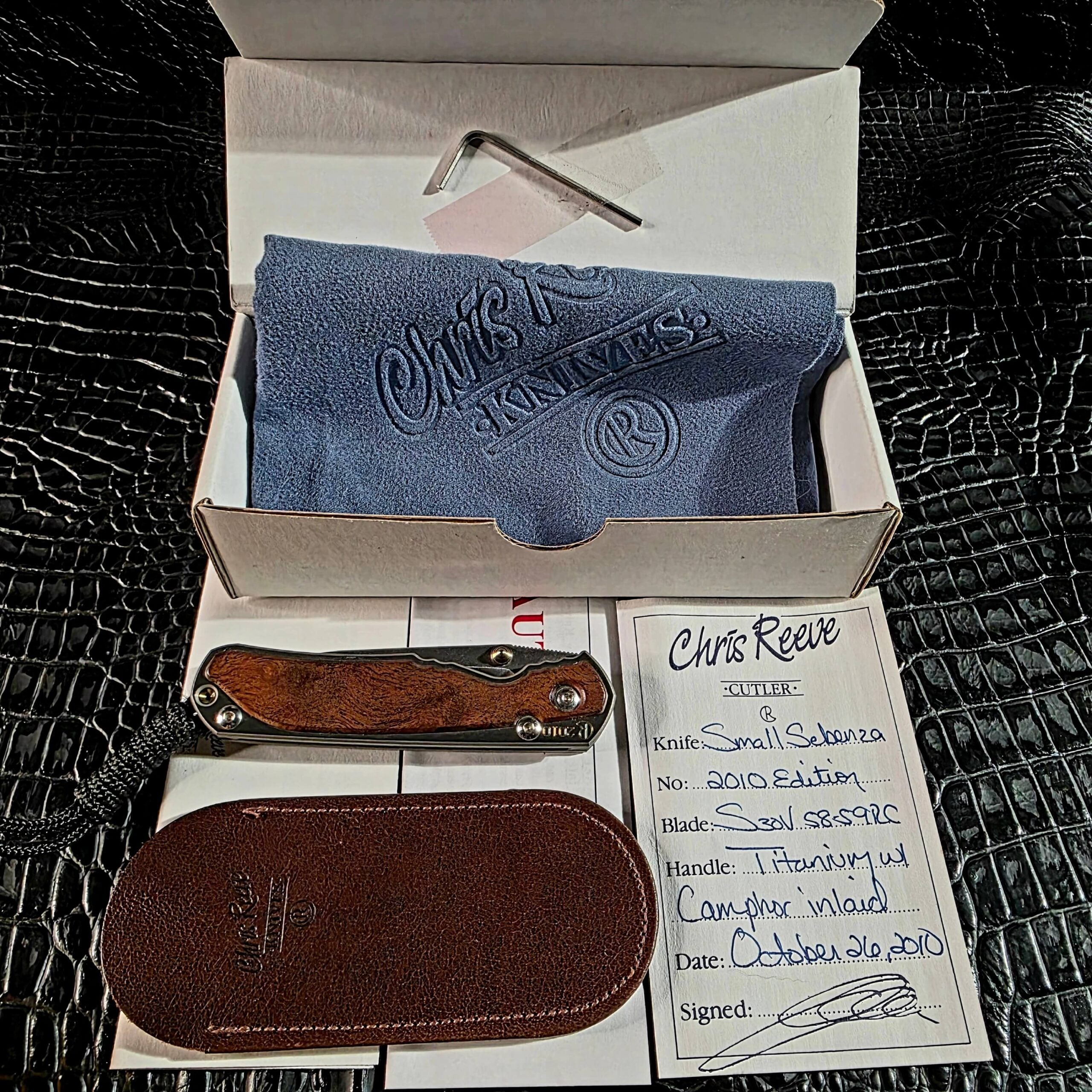 Chris Reeve Small Sebenza 2010 Annual with complete original accessories including signed certificate of authenticity, box, leather pouch, cleaning cloth, and hex wrench