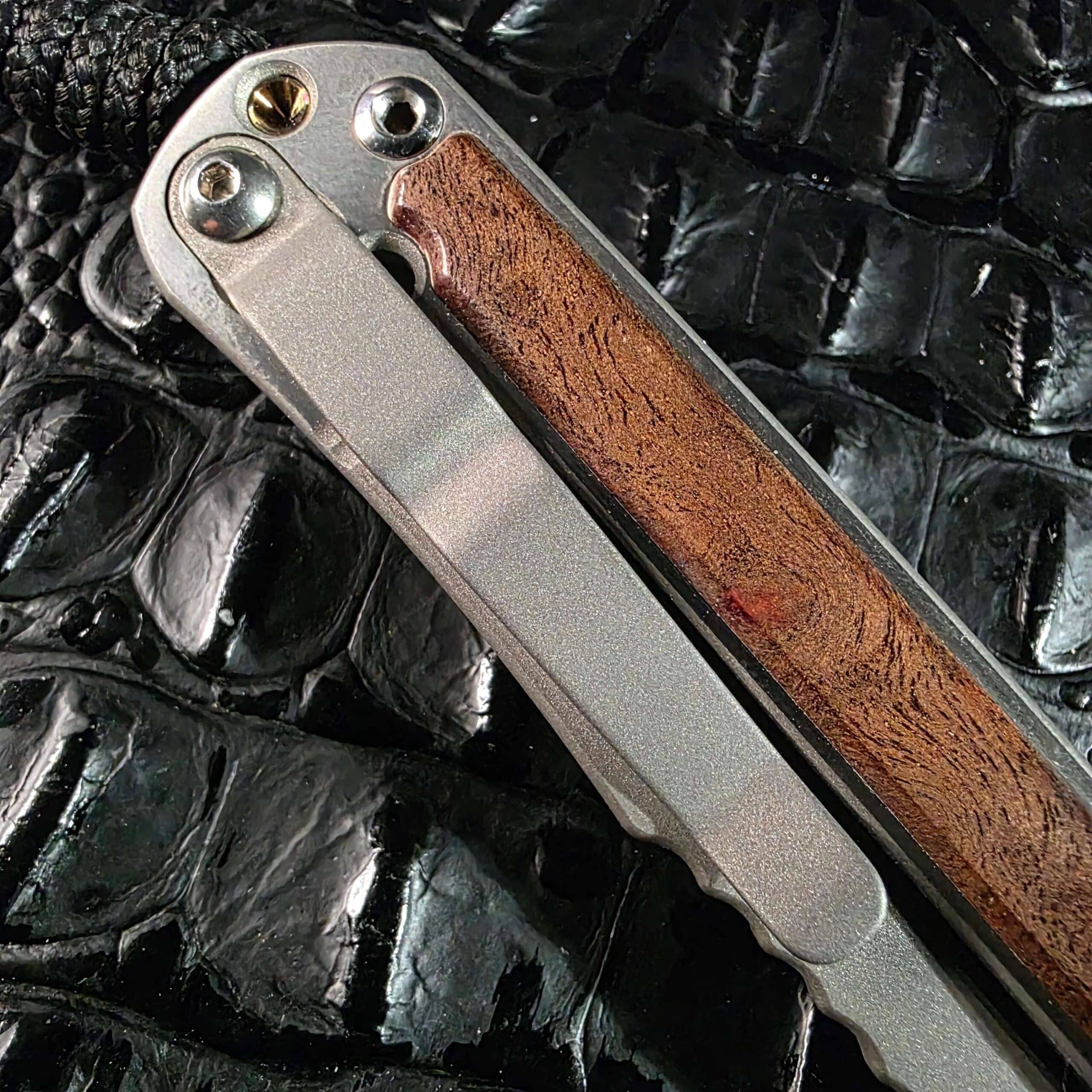 Closed lock side of the Chris Reeve Small Sebenza 2010 Annual with titanium pocket clip, Idaho Made engraving, and camphor inlay
