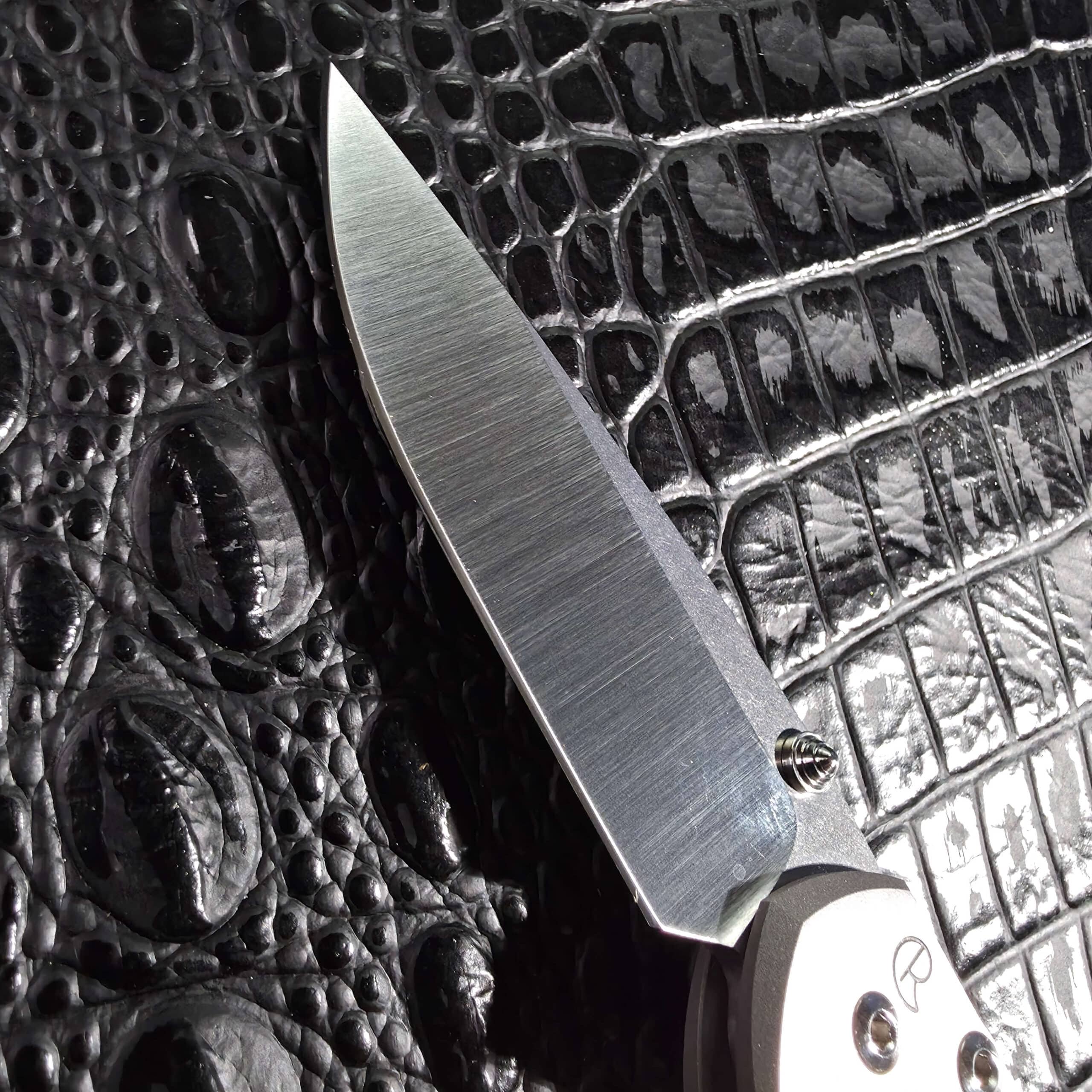 Long swedge and hollow grind on the polished CPM S35VN blade of a Small Sebenza 21