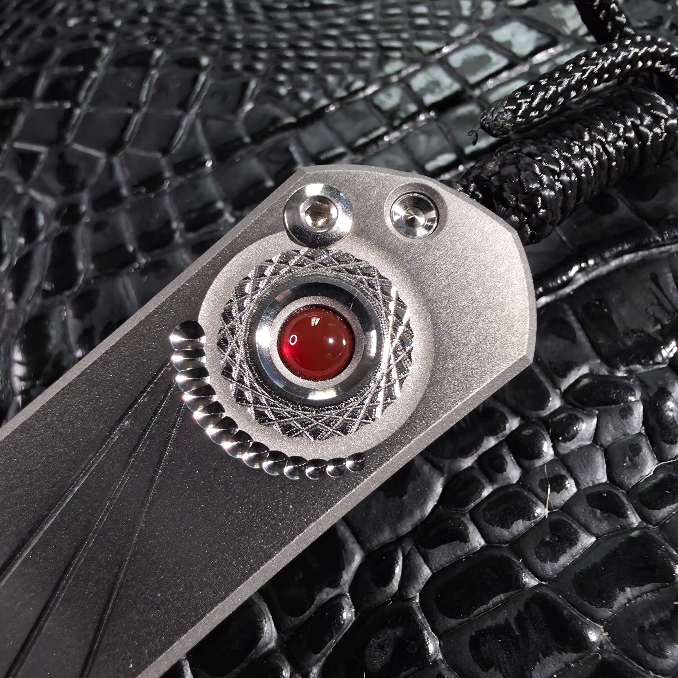 Macro of the polished carnelian cabochon and engraved bezel on a Chris Reeve Small Sebenza 21