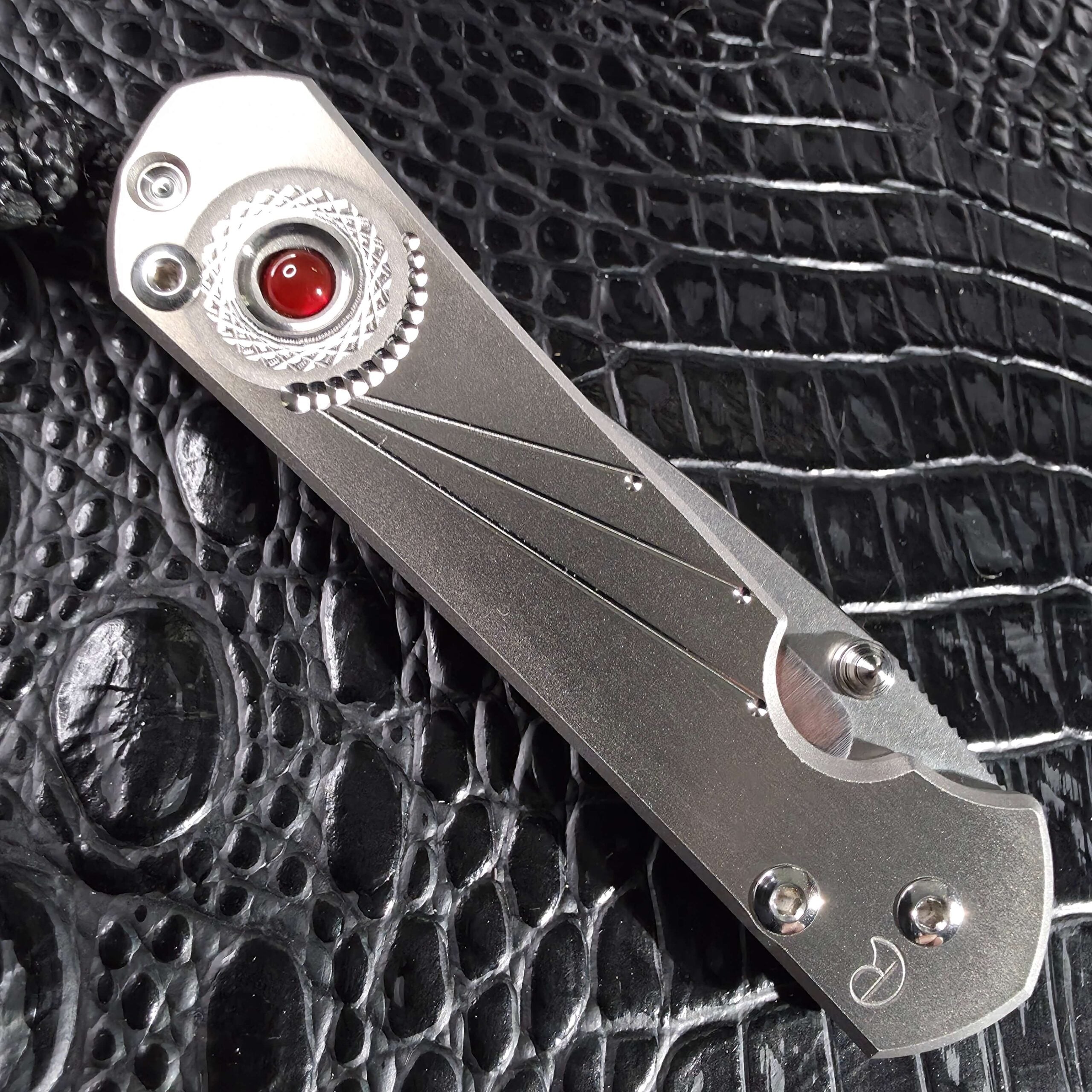 Closed Chris Reeve Small Sebenza 21 Carnelian show side with cabochon and maker's mark