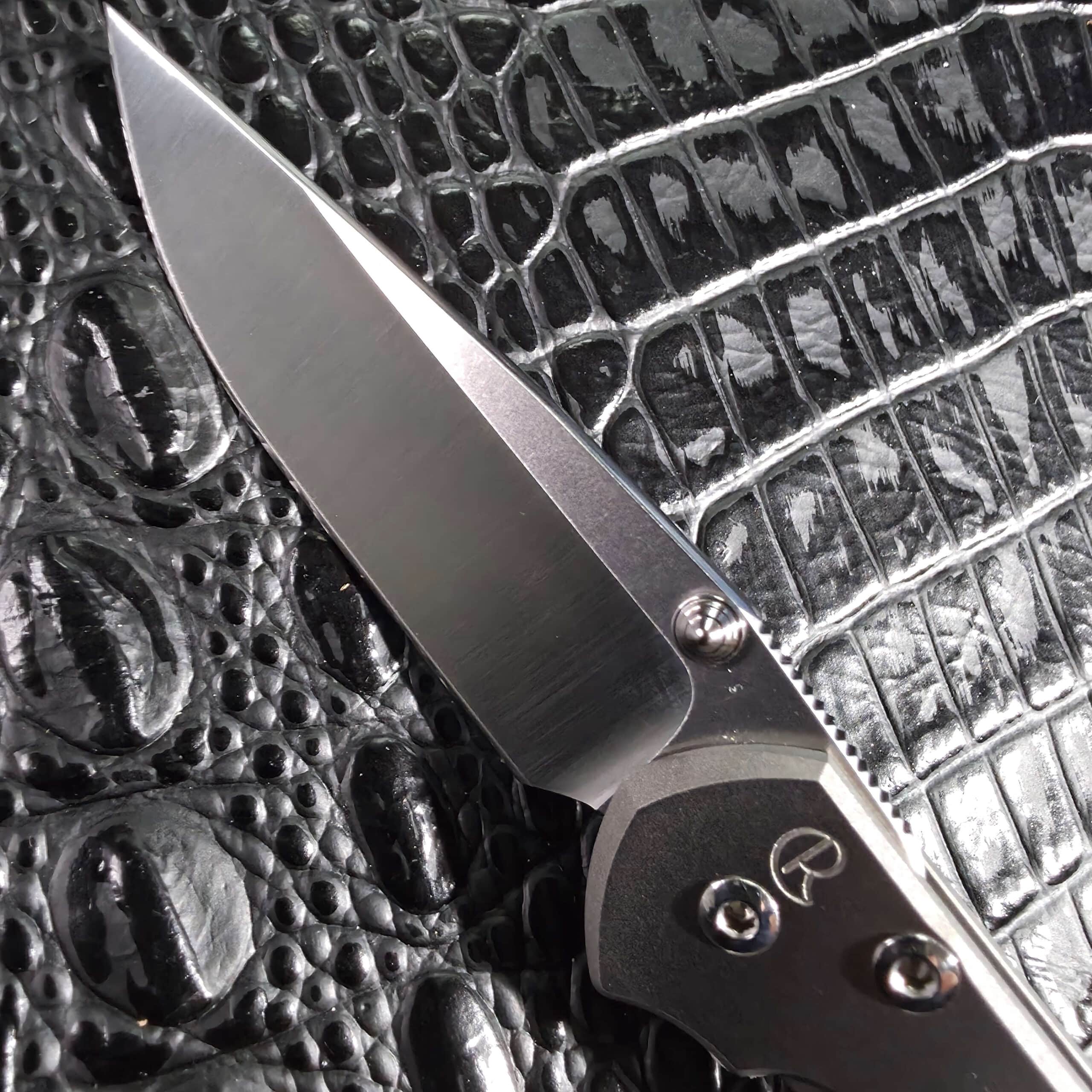 Chris Reeve maker's mark engraved beside the polished S35VN blade on the Small Sebenza 21