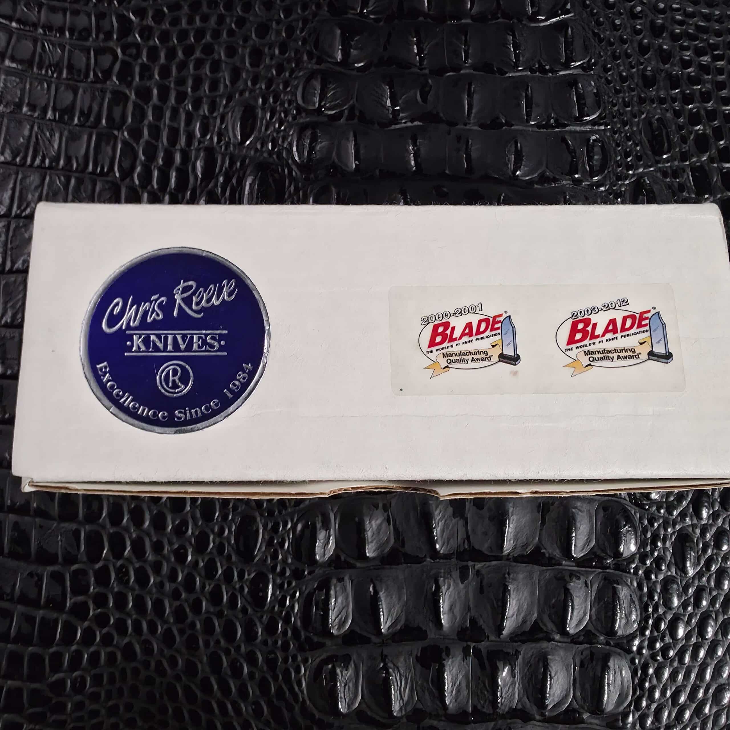 Original Chris Reeve Knives box with blue seal and Blade Magazine Manufacturing Quality Award stickers